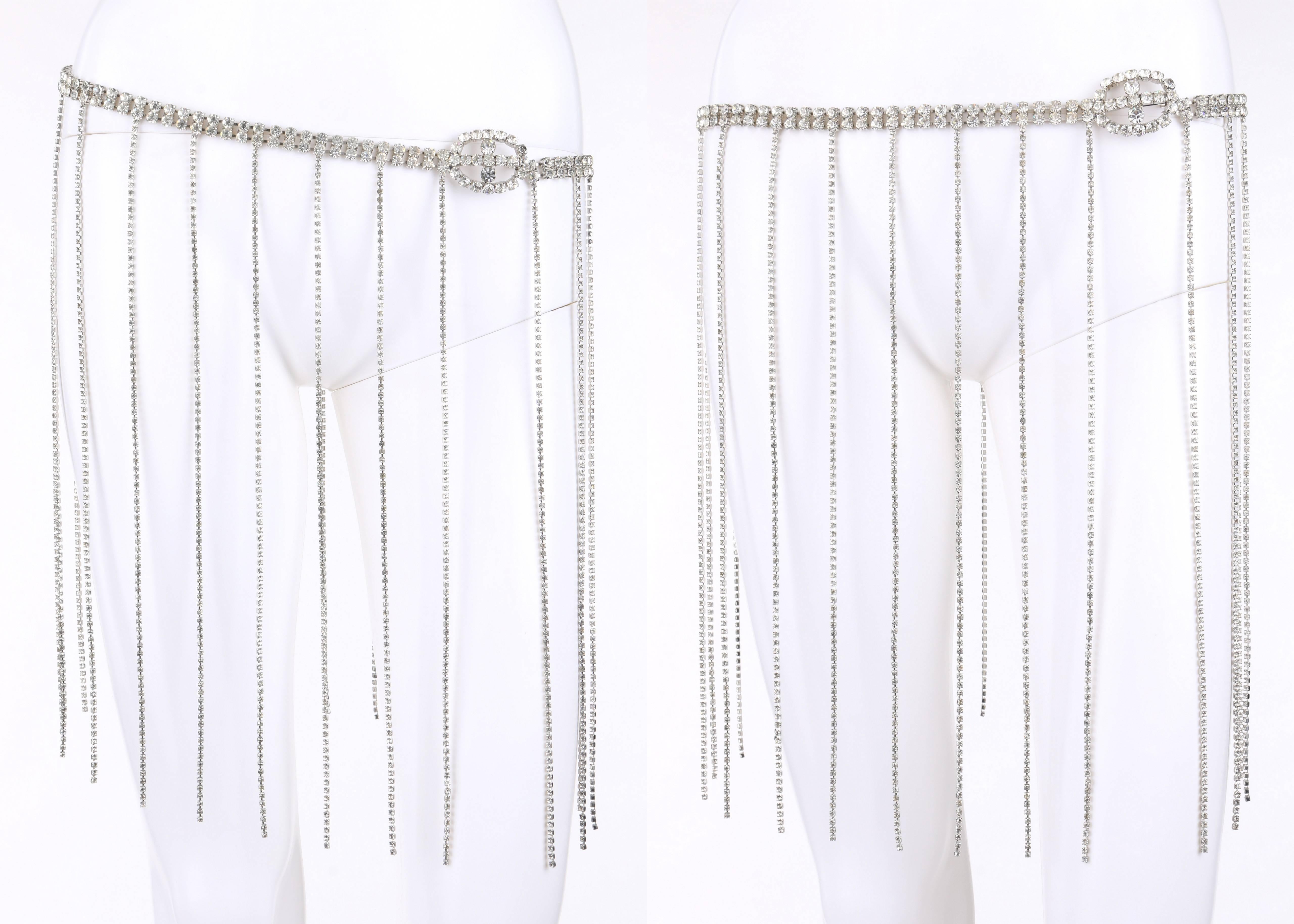 Vintage silver rhinestone 1920's flapper style fringe evening belt. Double row silver rhinestone chain body. Oval shaped rhinestone buckle with hook clasp. Twenty-four thin rhinestone fringe drops. Measurements: 

Total length: 31