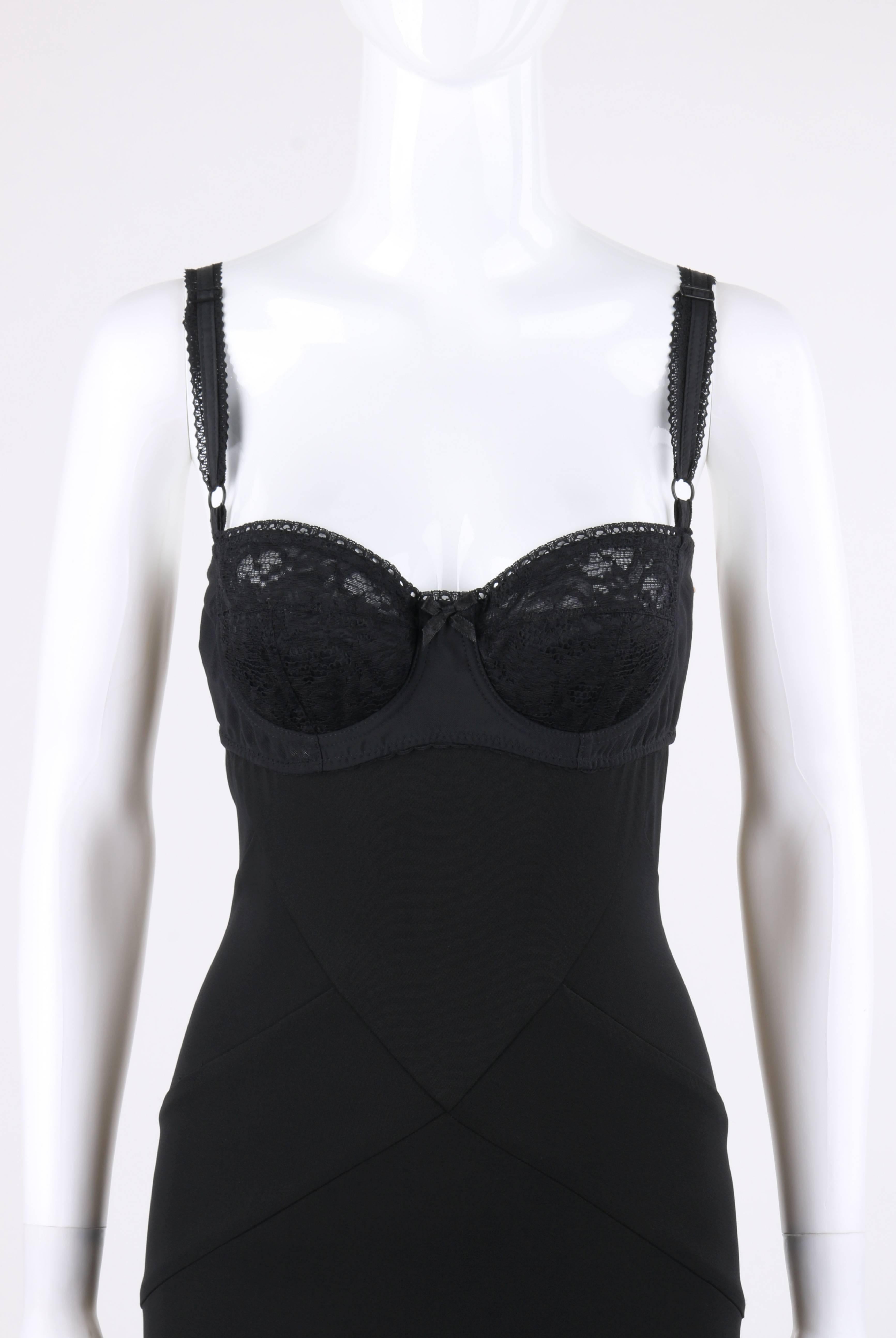 Dolce & Gabbana Autumn/Winter 1996 black knit lace bustier empire cocktail dress. Built-in mesh bra with black floral lace cups. Underwire. Center front bow detail. Adjustable scallop lace detail straps. Long shift style. Empire waistline. Center
