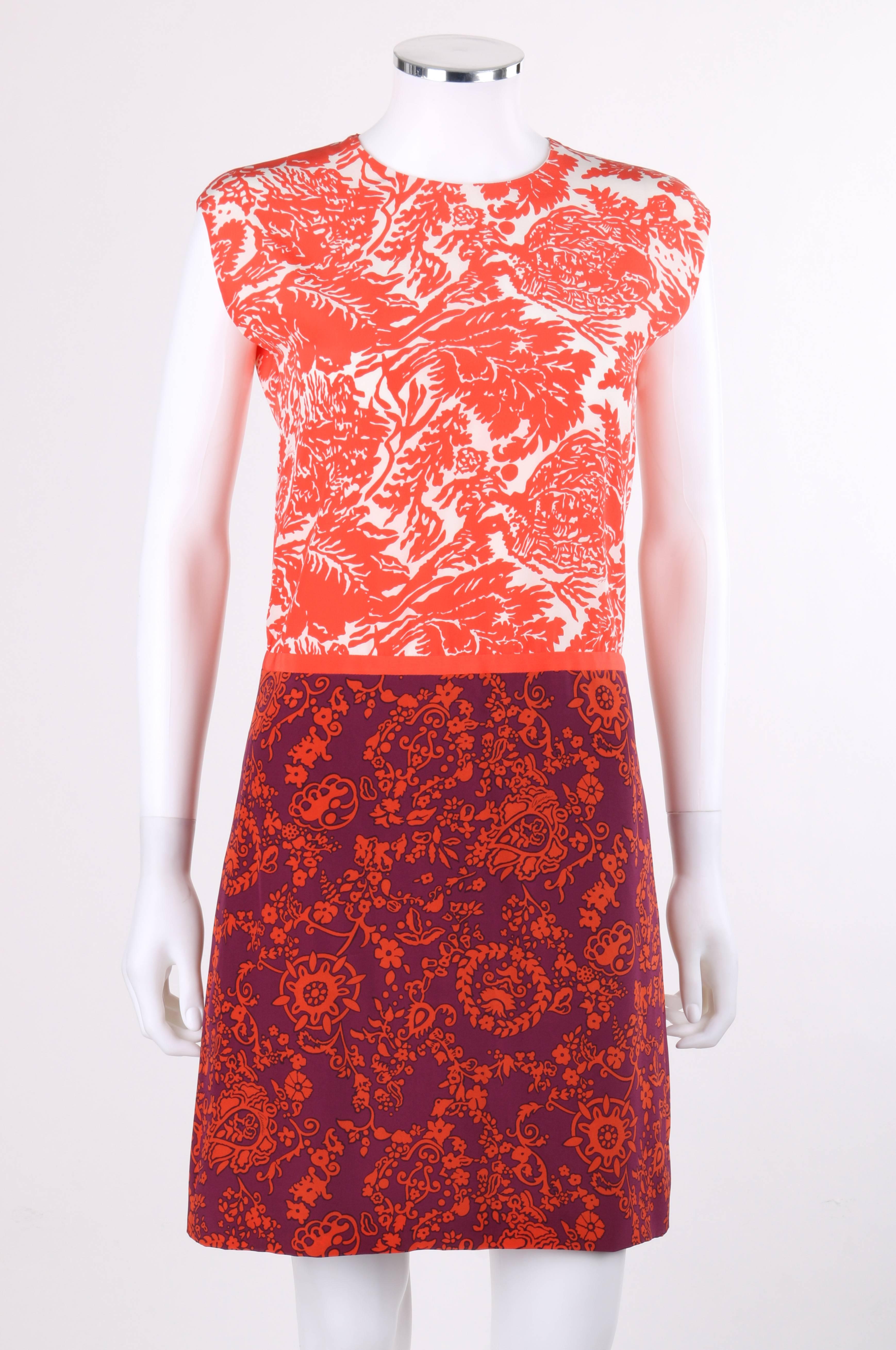 Gucci Resort 2012 orange and purple dual floral print silk color-block shift dress; New with tags. Dual Gucci signature floral prints; orange and white tropical floral print bodice and orange and purple ornate print skirt. Scoop neckline. Extended