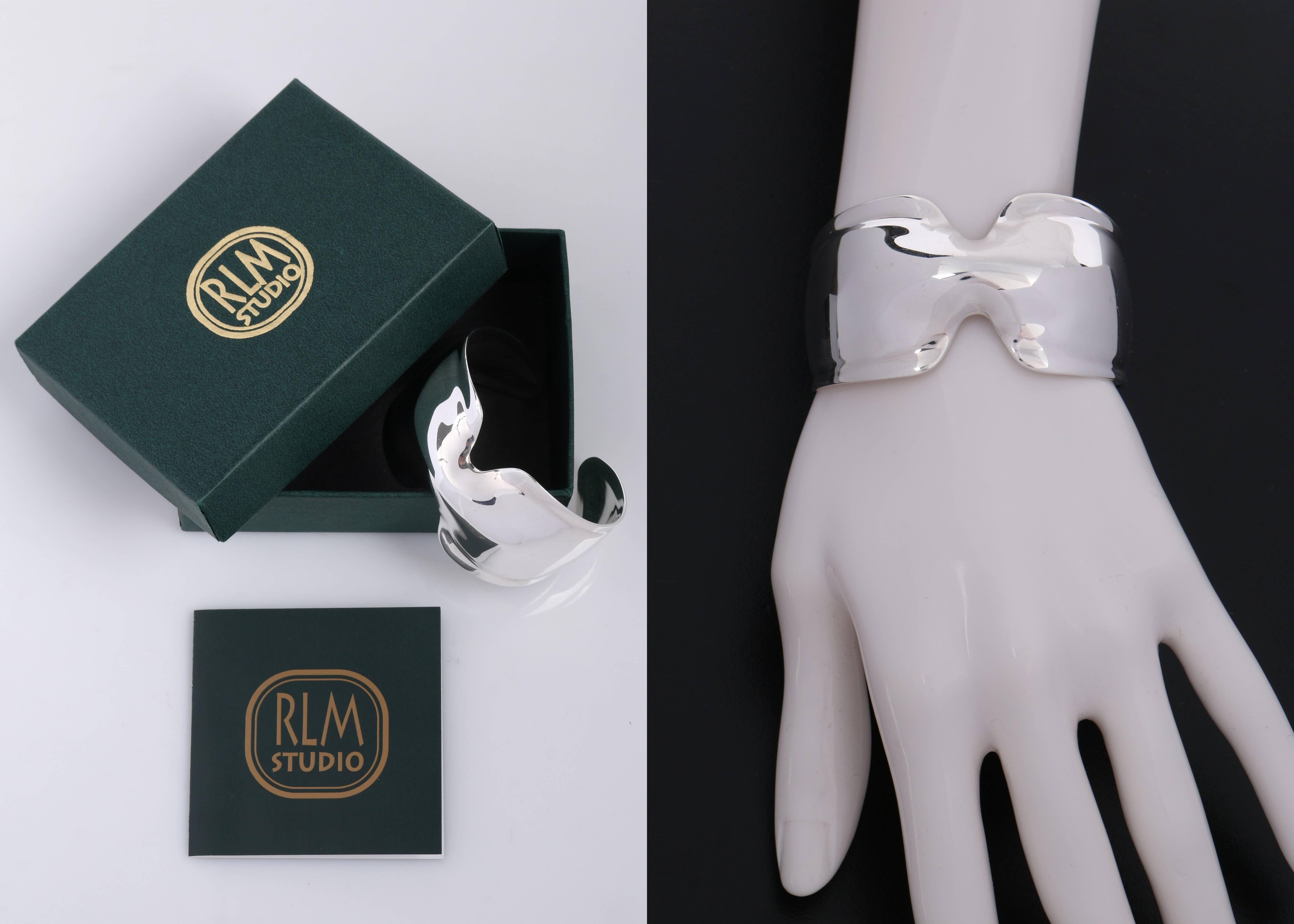 RLM Studio by Robert Lee Morris pinched sterling silver (.925) modernist cuff bracelet. Polished sterling silver cuff with pinched center detail. Thin beveled edge. Slip on style. Marked: 