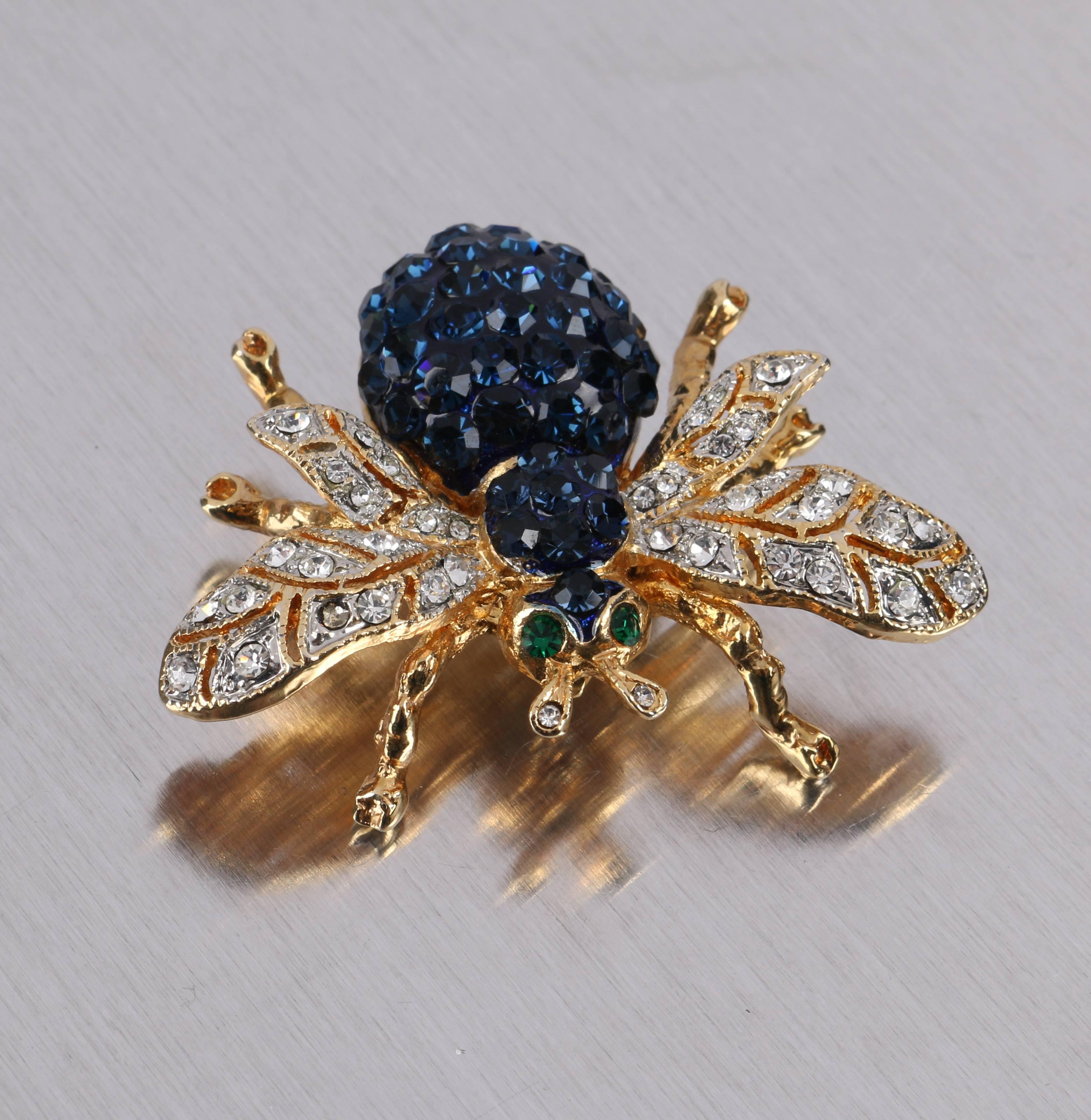 c.1990's sapphire blue crystal rhinestone and gold-toned bee figural brooch. Gold-toned metal body with pave set rhinestone crystals throughout. Cut work wings with clear pave set rhinestones. Segmented body with sapphire pave set rhinestones. Two