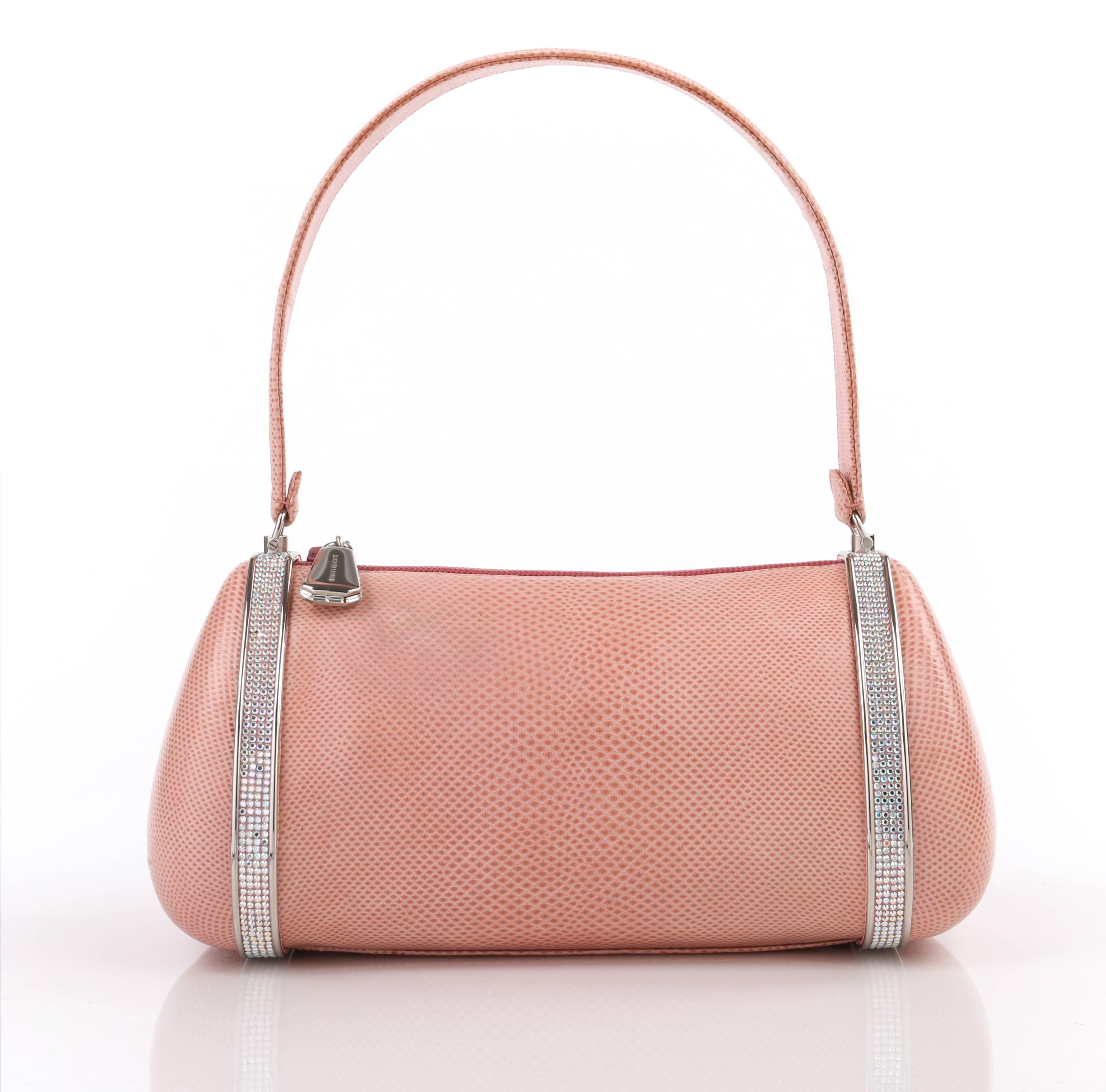 Judith Leiber c.1990's pink lizard leather and crystal rhinestone baguette. Pink lizard leather exterior with structured hard case sides. Single flat leather top handle. Silver-toned metal detail at either end with pink aurora borealis crystal