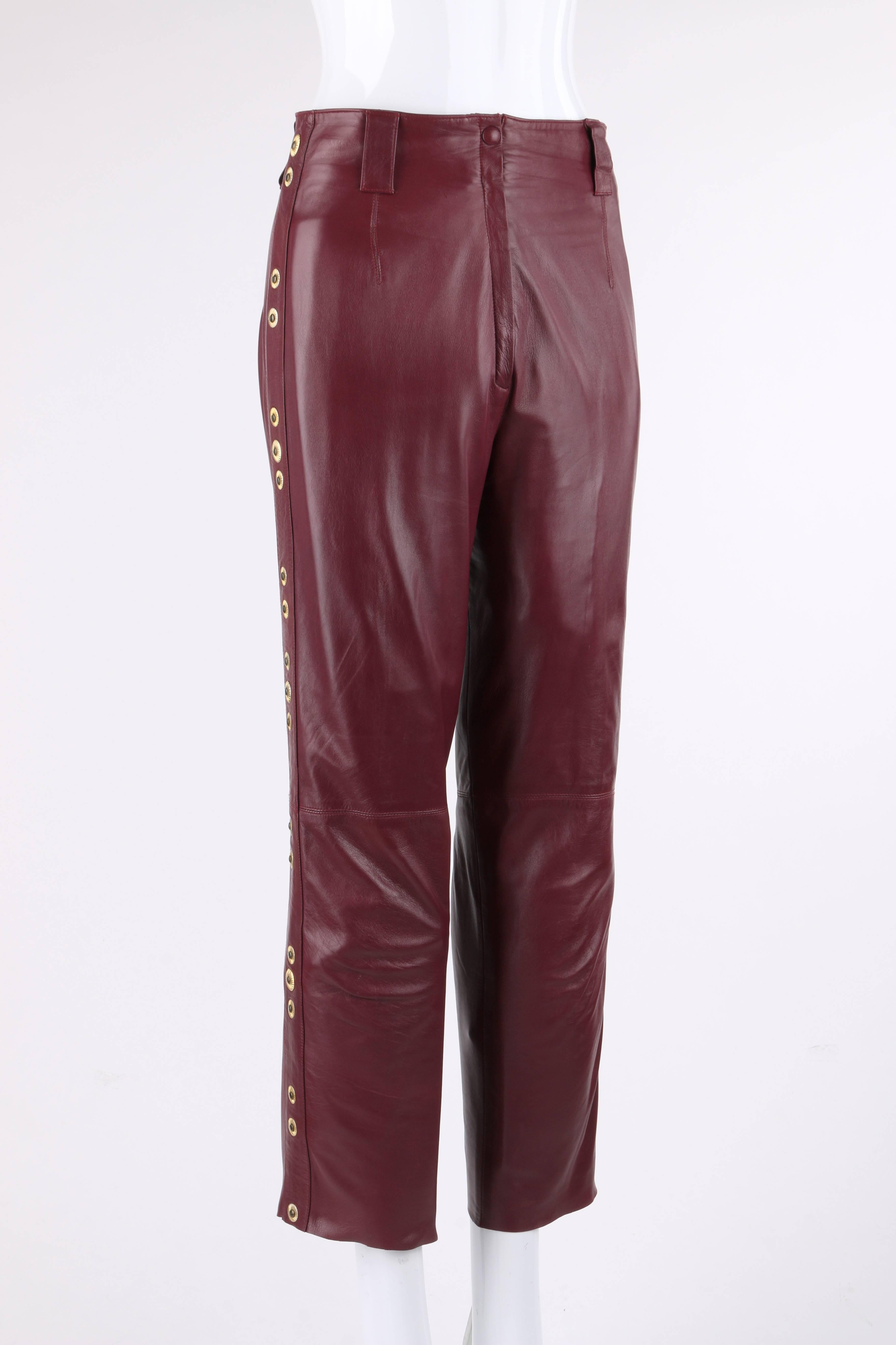 Roberto Cavalli burgundy red leather stud embellished pants. Tapered cut ( ankle length) and cropped or petite style. Five belt loops. Center front zip fly with single covered snap closure. Two front and back waistline darts. Side seam panels with