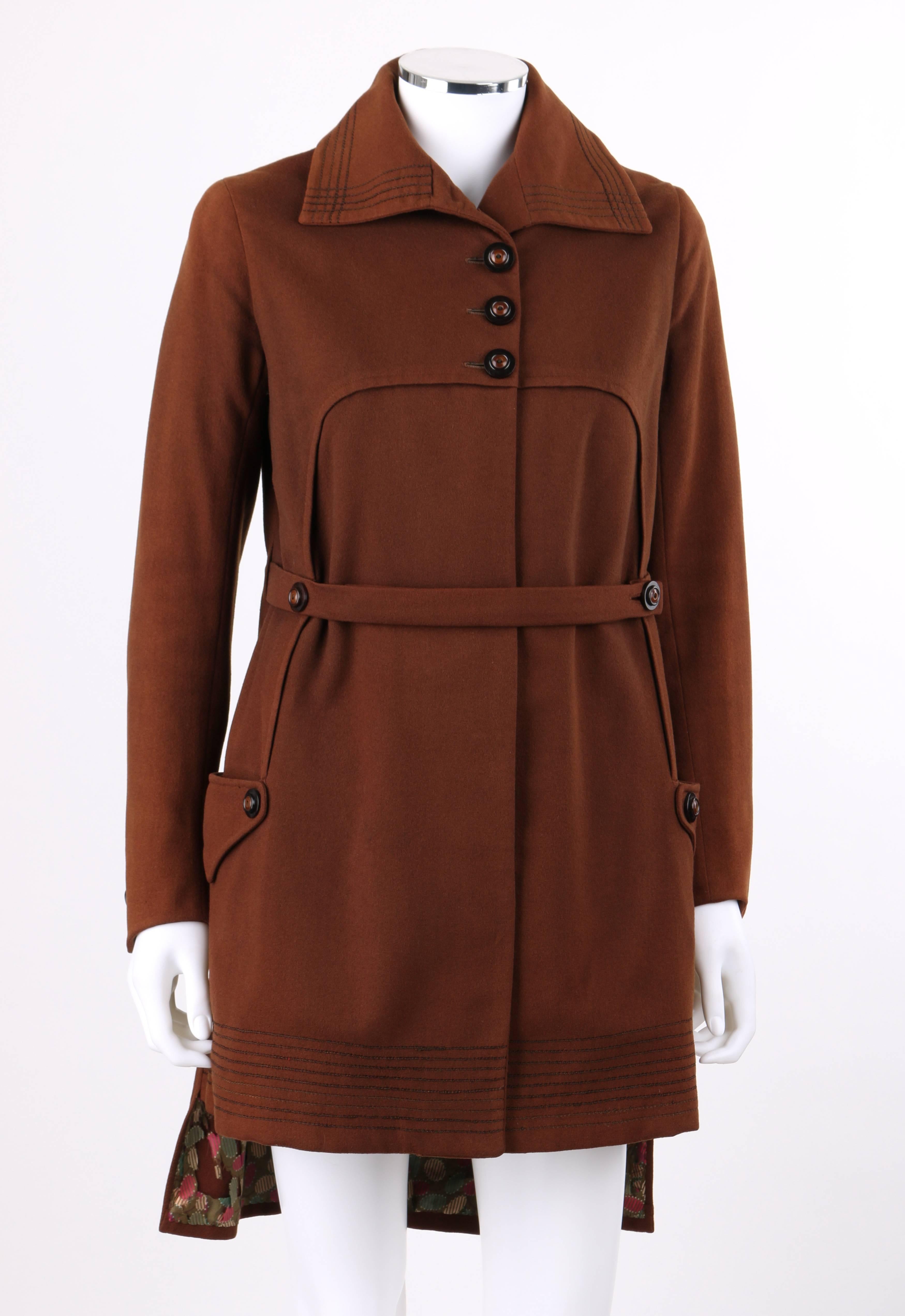 Vintage Couture c.1910's WWI brown wool belted military-cut belted coat. Bal collar with thin cord embroidered detail along edge. Five center front black and brown button closures and single snap closure at waist. Long sleeves with two button detail