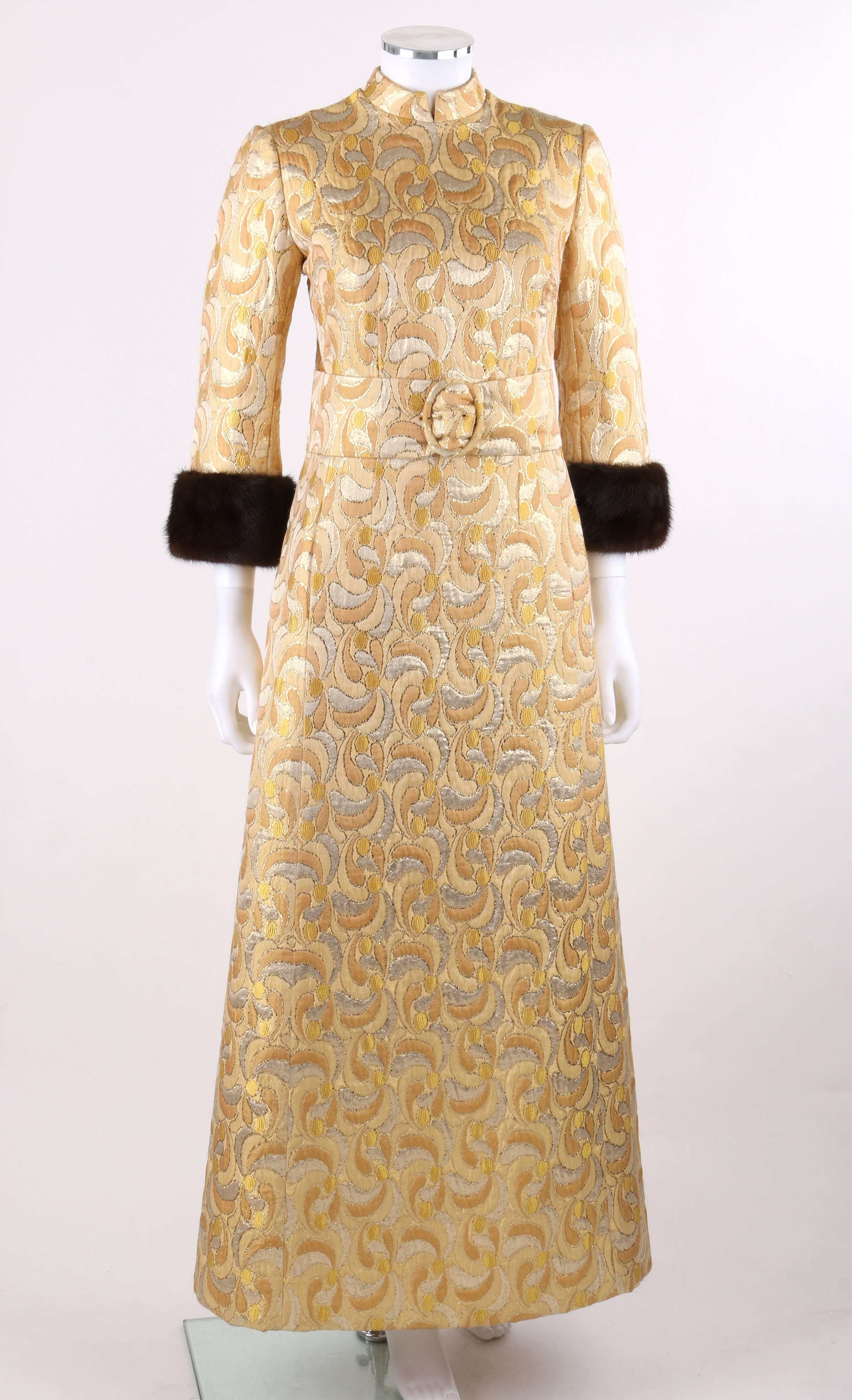 Vintage Lillie Rubin c.1960's metallic brocade brown mink fur cuff belted caftan evening dress. Metallic floral patterned brocade with shades of gold, silver, and beige. Mandarin collar with slit at center front. 3/4 sleeves with brown mink fur