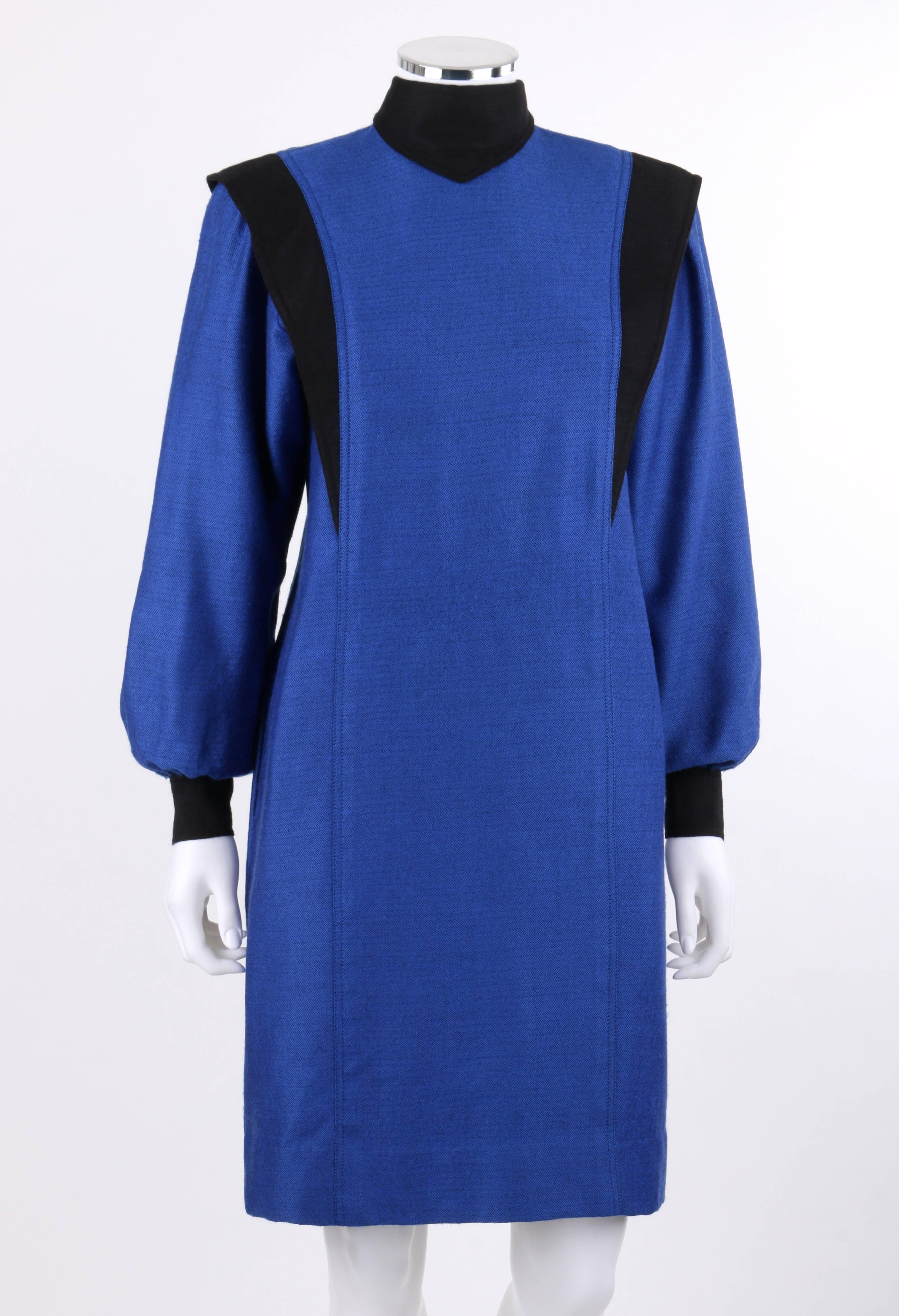 Vintage Balenciaga c.1980's blue and black wool herringbone bishop sleeve shift dress. Black mandarin collar with pointed center front fold. Long bishop sleeves with two button closures at contrasting black cuffs. Two contrasting black herringbone