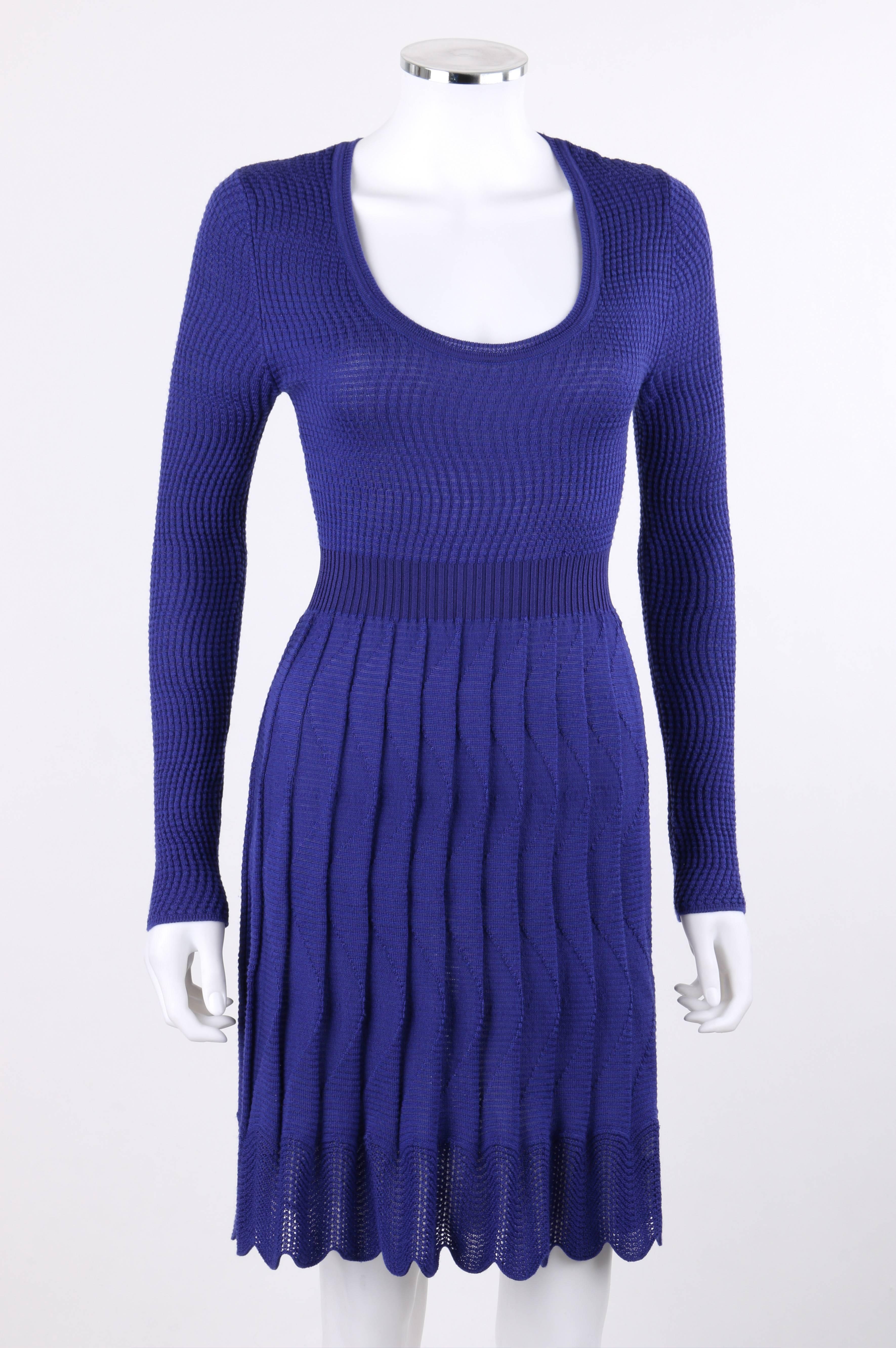 Missoni royal blue (with a hint of purple) wool rib knit long sleeve pleated shift dress. Designed by Angela Missoni. Wave patterned rib knit bodice. Long sleeves. Scoop neckline. Rib knit banded waistline. Knife pleated skirt with scalloped