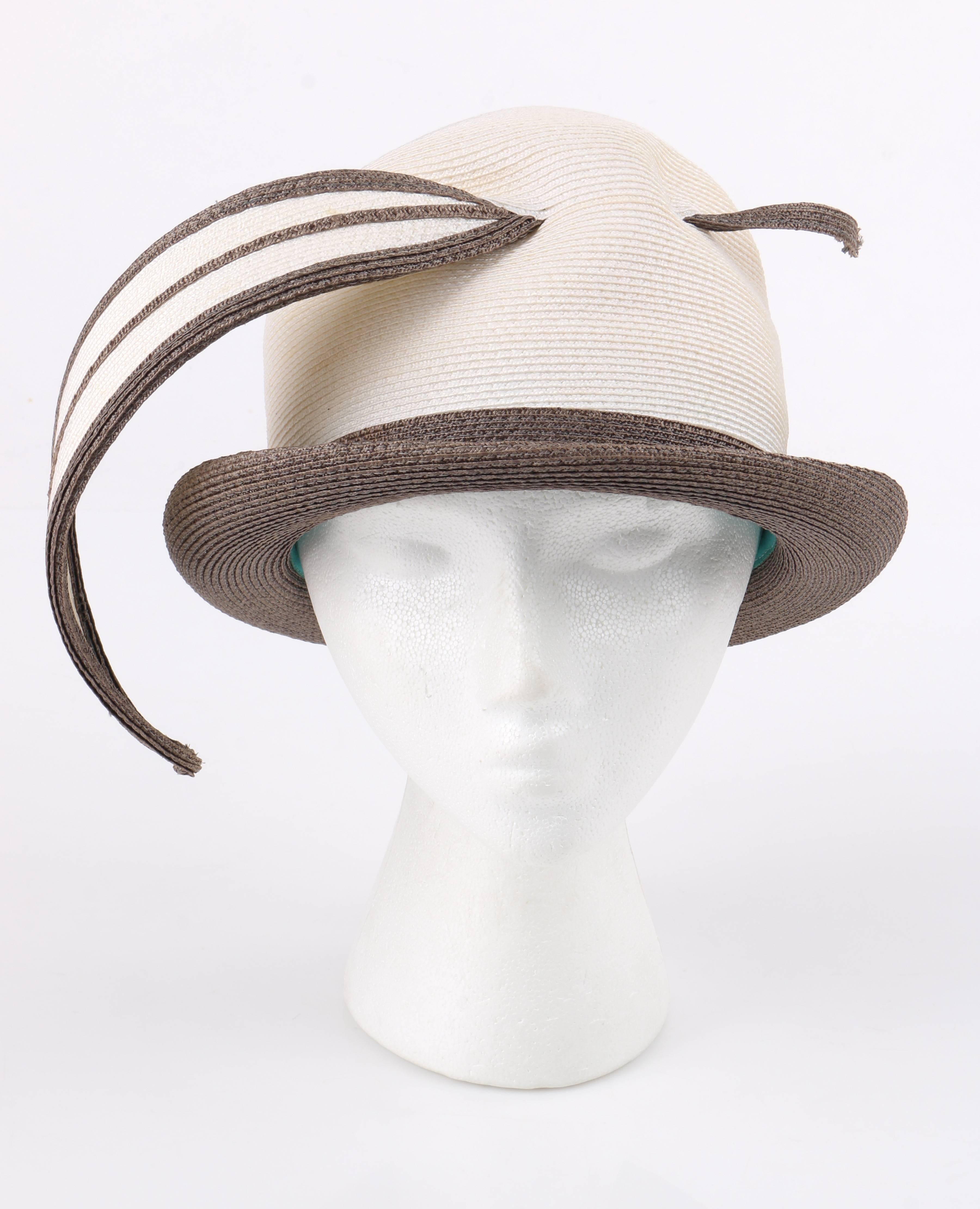 Vintage Yves Saint Laurent YSL c.1965 - 67 off white and taupe straw sculptural leaf cloche hat. White straw bell shaped crown. Taupe rolled brim and hat band. Large sculptural leaf woven through front of crown. Teal blue grosgrain ribbon along