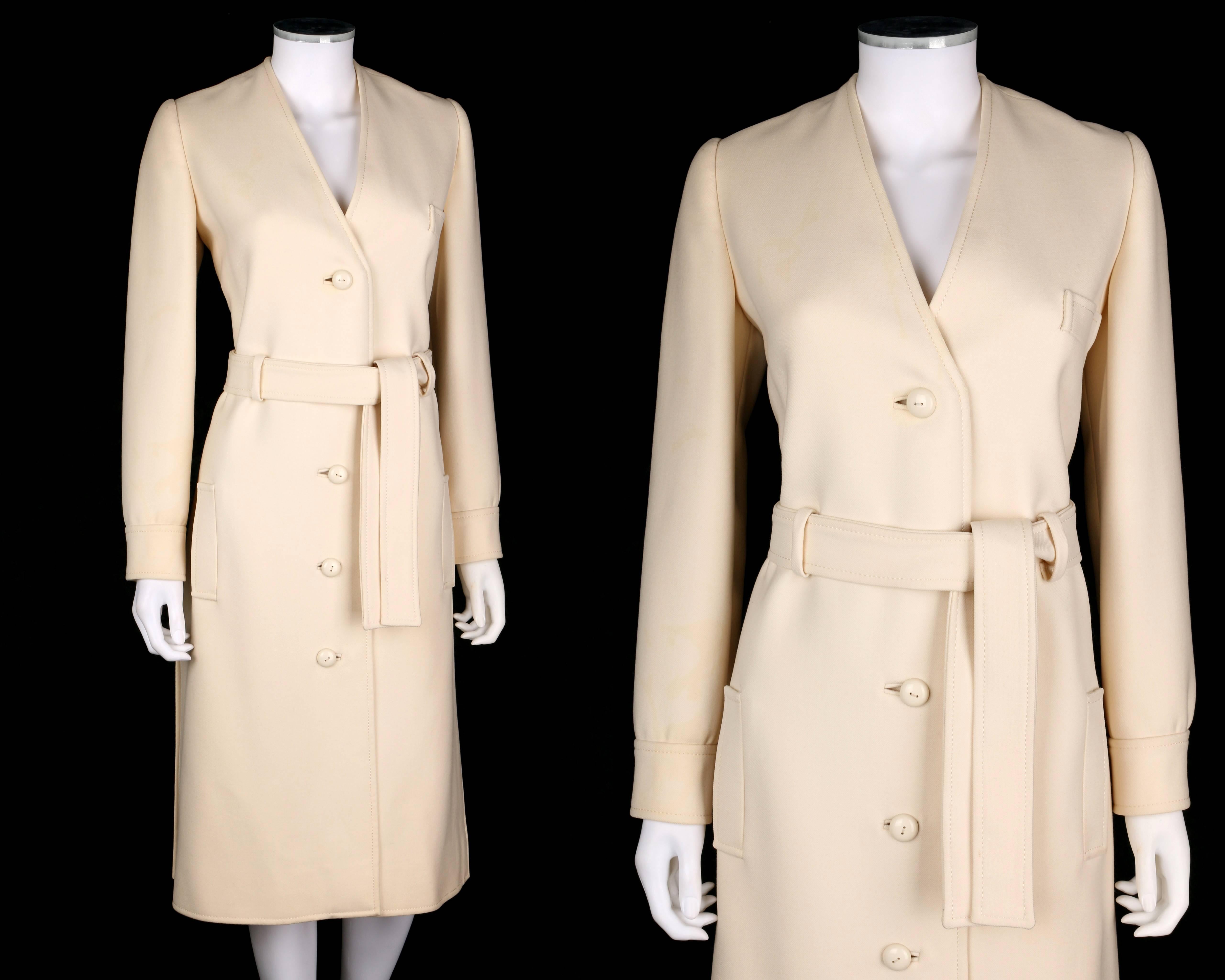 Rare vintage Boutique Valentino c.1960's off white wool belted mod v-neck coat dress. Off white heavy weight wool. Long sleeves with two button closures at cuff. V-neckline. Four center front button closures. Single welt breast pocket. Two single