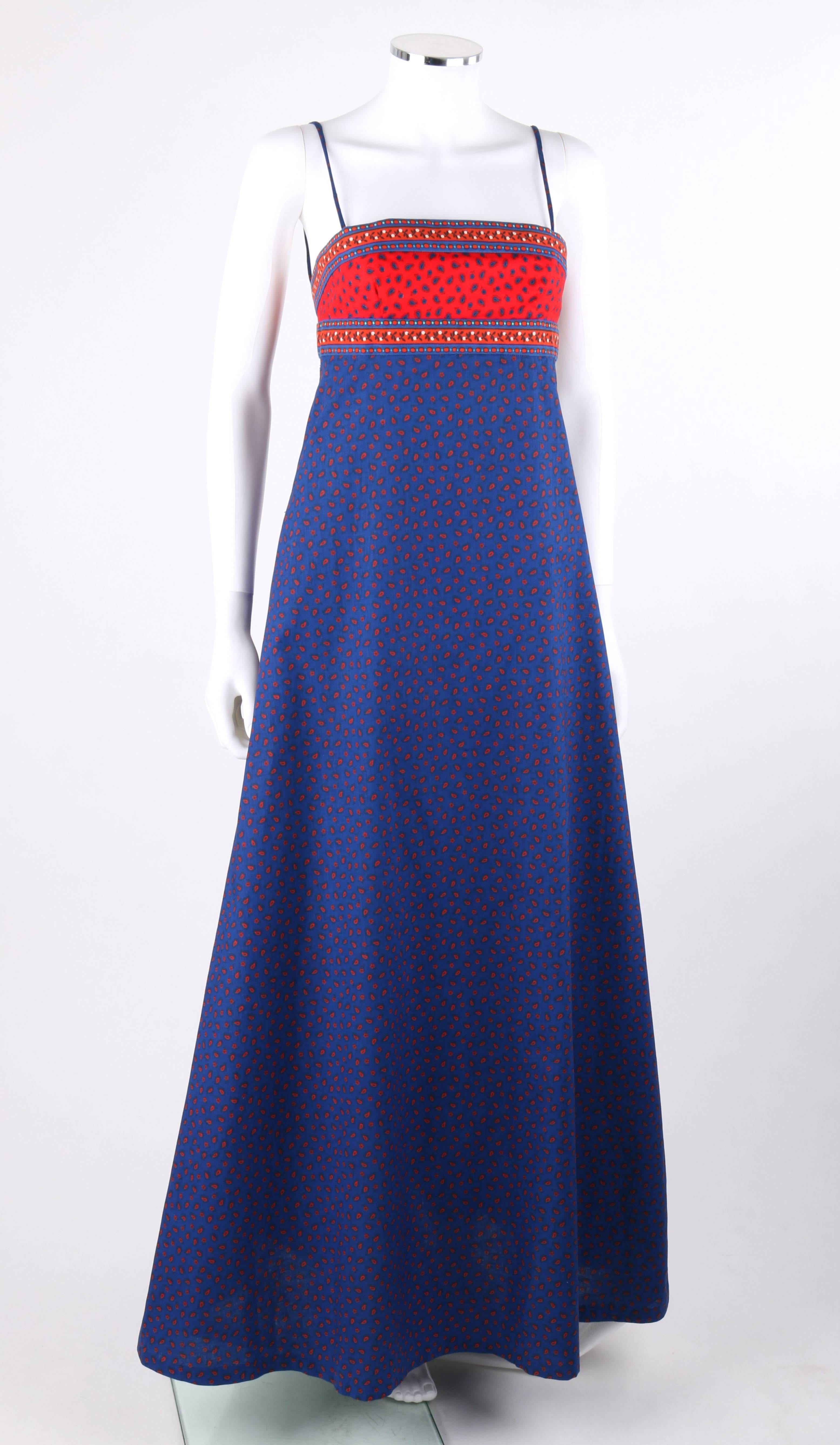 Vintage Anne Klein c.1970's blue and red floral paisley print empire waist maxi dress. Designed by Donna Karen. Spaghetti straps. Empire waist. Floral boarder print at top of bodice and waistline. Low back with double bow detail. Center back zipper