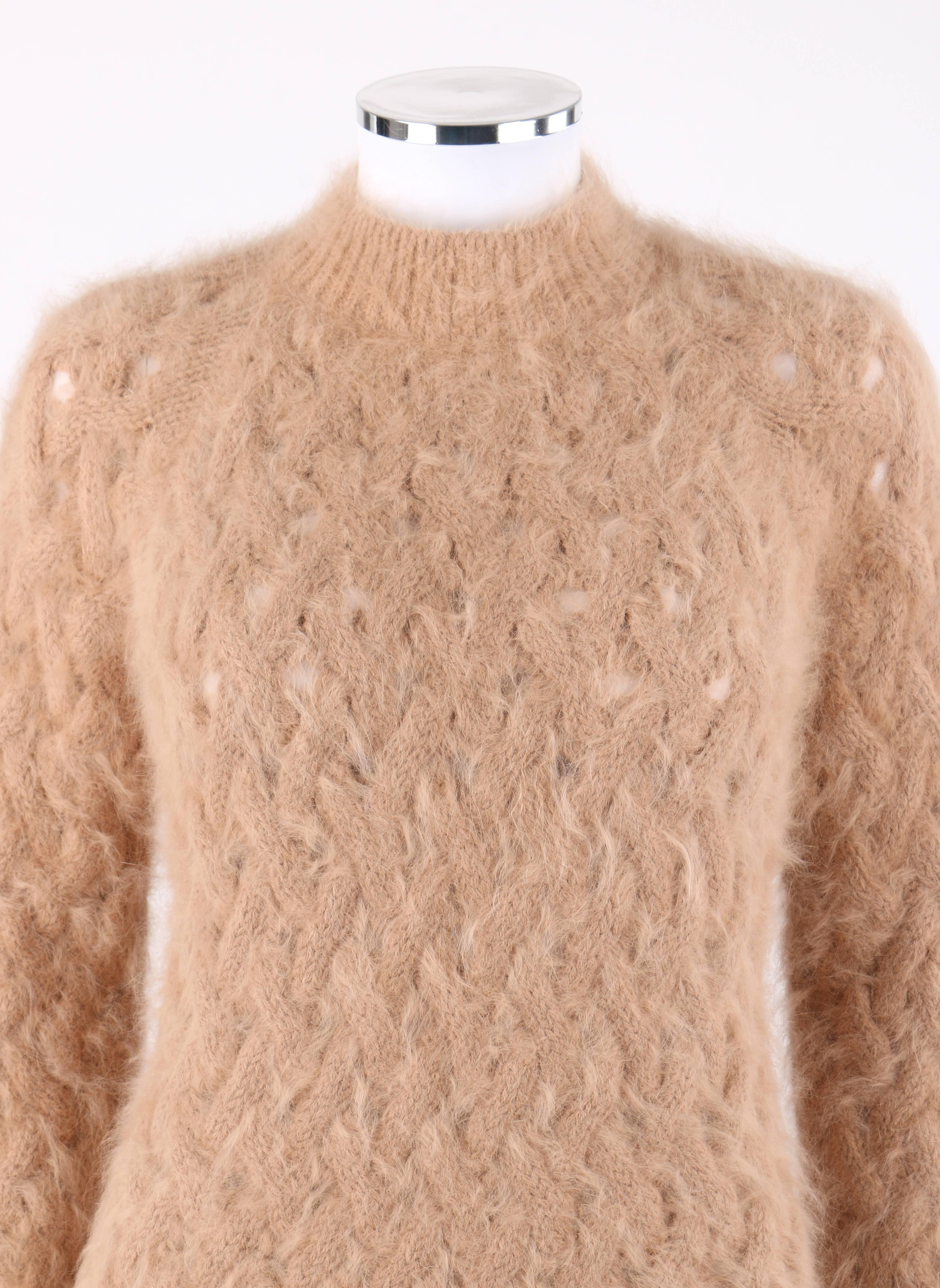 Balmain Paris Tan angora wool chunk cable knit pull over mock neck sweater. Angora wool blend chunky open cable knit. Long raglan sleeves. Mock neckline. Rib knit detail at neckline, cuffs, and hem. Pull over style. Marked Fabric Content: 