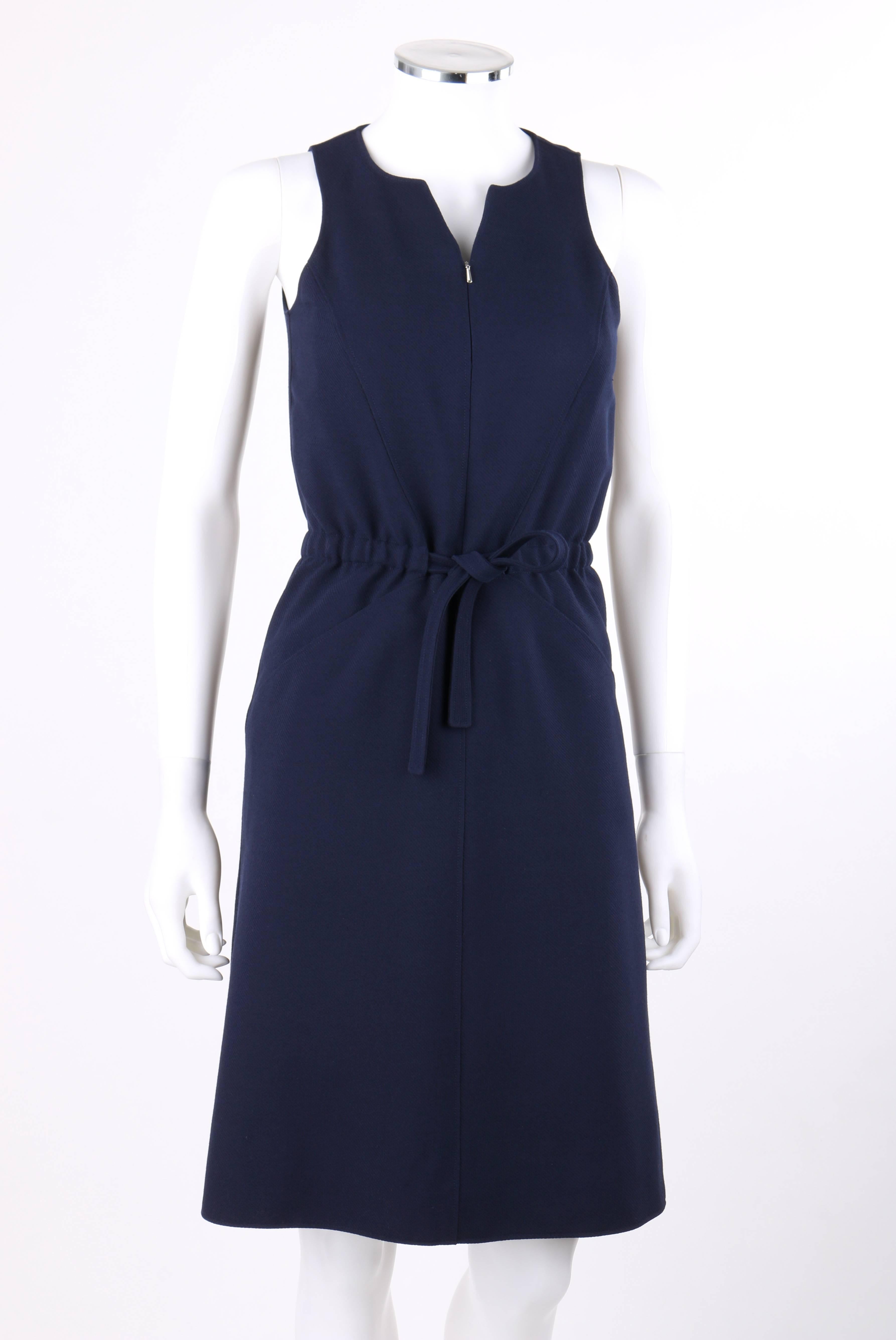 Vintage Courreges Couture Future c.1960's navy blue wool sleeveless tie waist shift dress. Designed by Andre Courreges. Slit neckline. Sleeveless. Center front 1/2 zip closure. Draw string waist with elastic at back. Two front hip pockets. Angled
