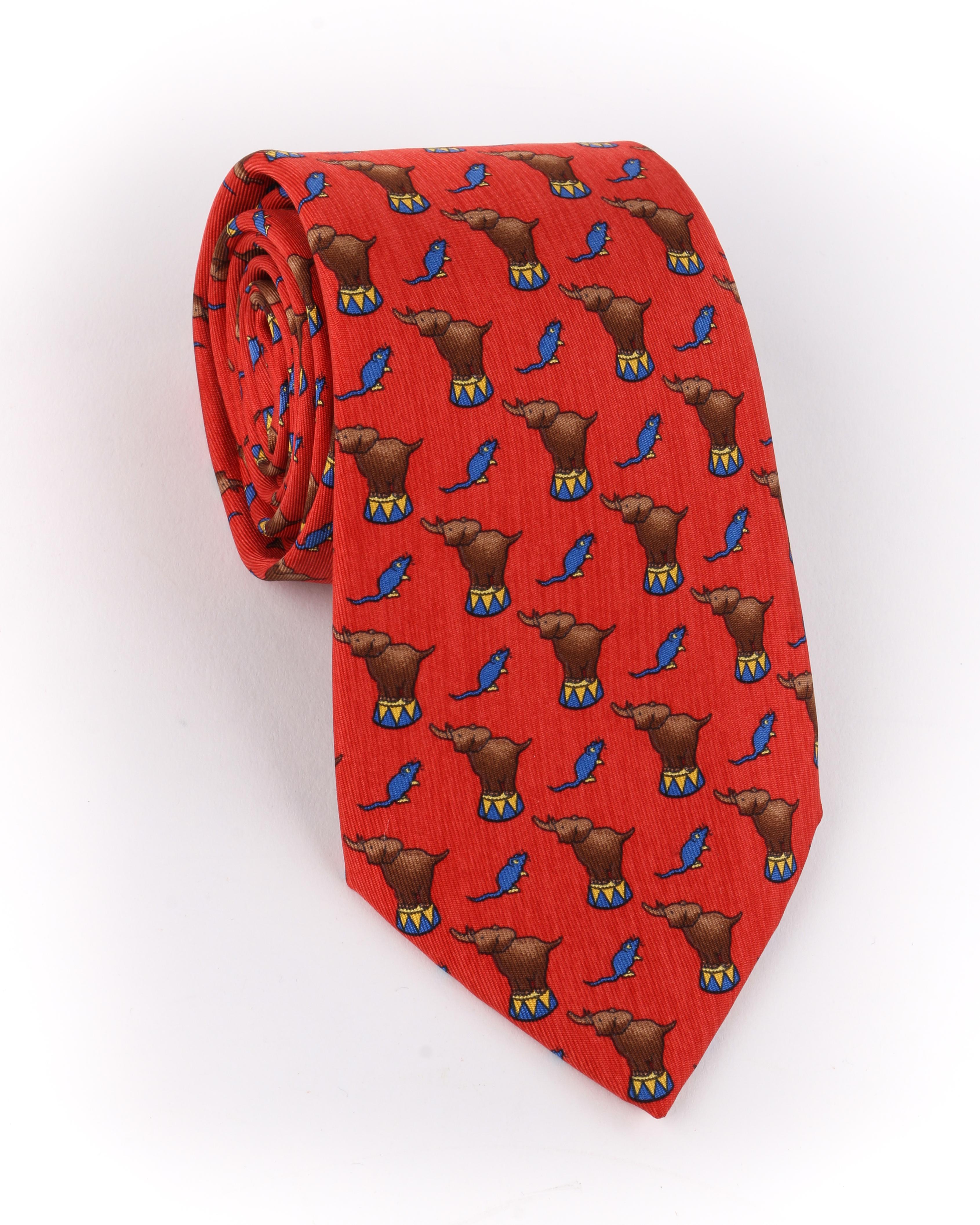 DESCRIPTION: HERMES Red Circus Elephant & Mouse Print 5 Fold Silk Necktie Tie 7681 TA
 
Brand / Manufacturer: Hermes
Collection: 
Designer: 
Manufacturer Style Name: 
Style: 5 fold necktie
Color(s): Multi in shades of red, brown, blue, and