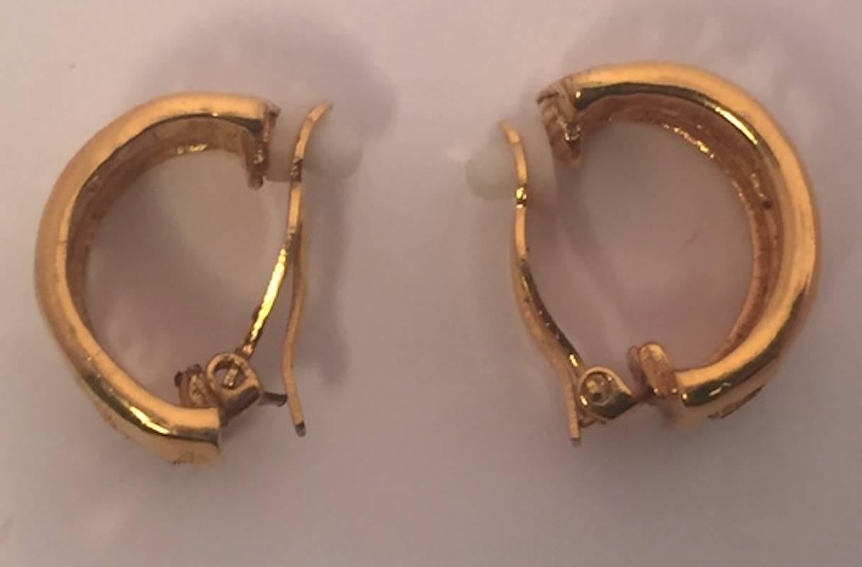 From the early 1980s, these half hoop earrings are 1/5 inch (1.3 mm) wide and 1 inch (2.5 m) tall. The word 