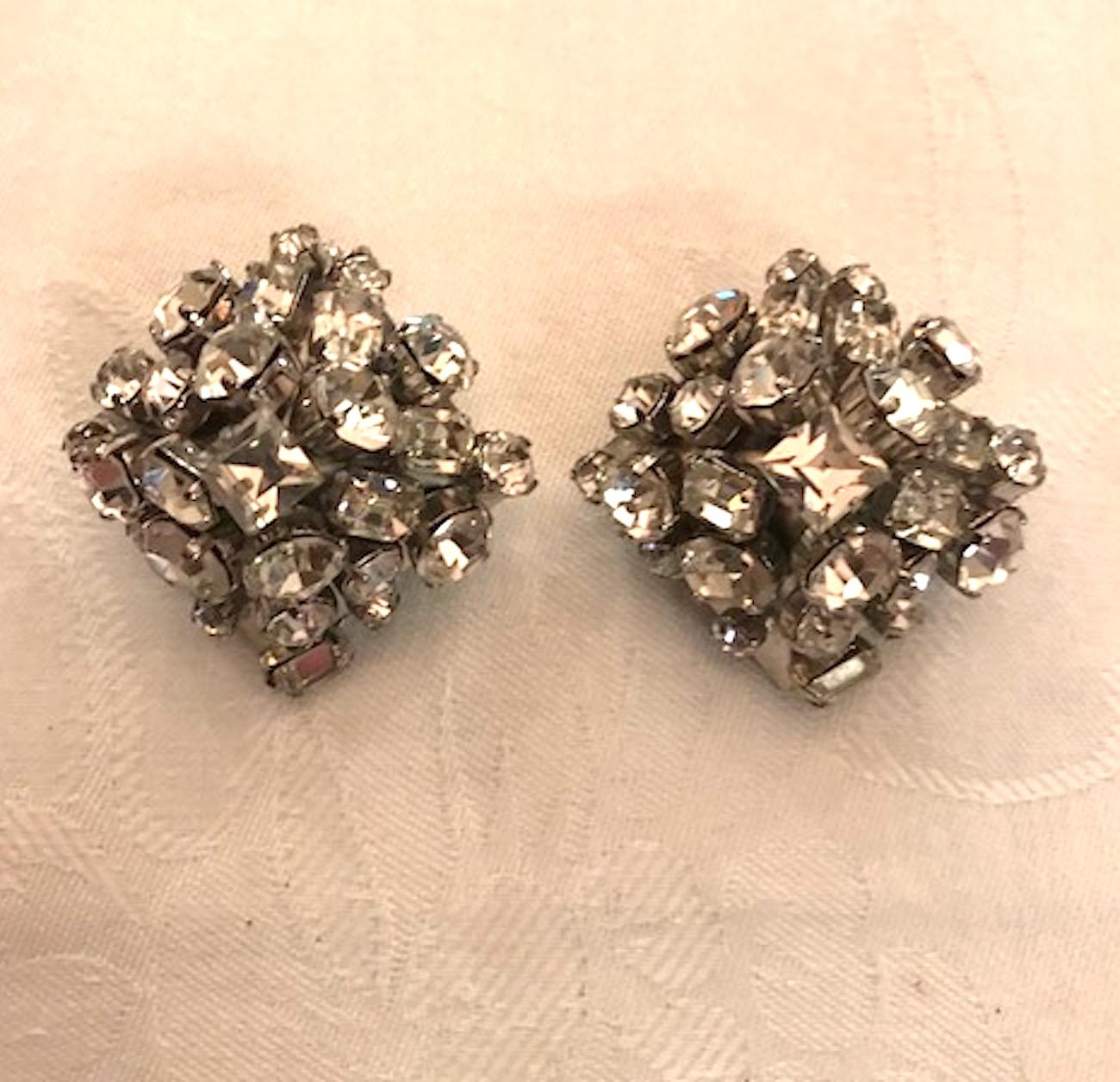 A very chic and fashion forward pair of Elsa Martinelli's De Liguoro pyramid rhinestone earrings. Rhodium plated metal pyramid are mounted with square, rouge and emerald cut rhinestones. Unsigned, however construction and use of round chrome lace