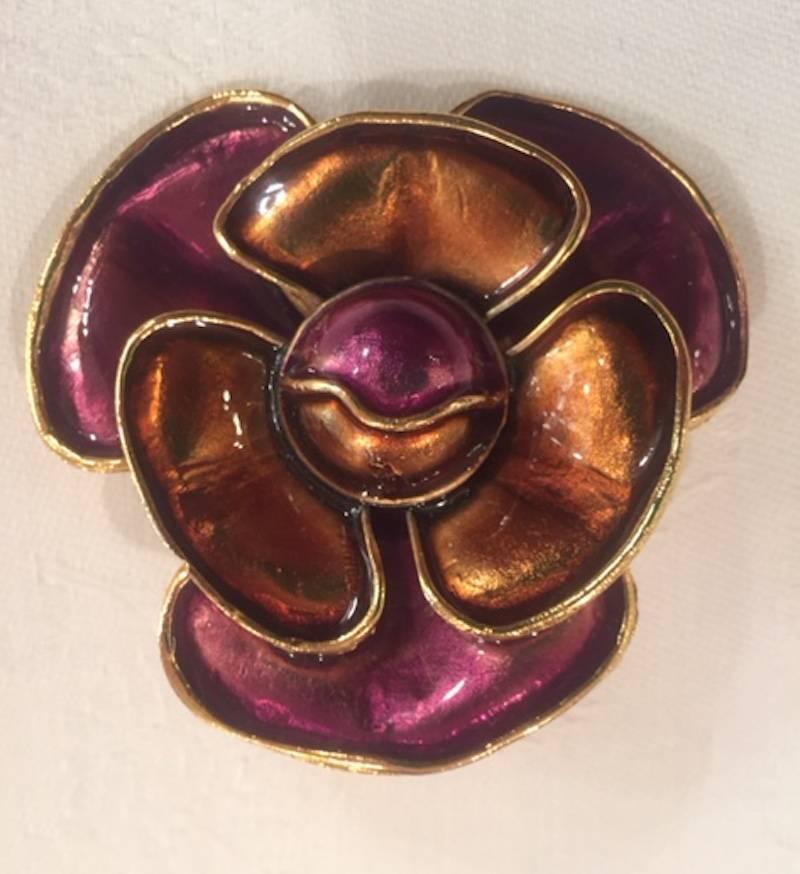 An amazing and large pair of flower clip earrings by Italian fashion house Krizia. Produced in the 1980s, the earrings are gold plate with gold/amber enamel on the three interior petals and purple enamel on the 3 outer petals. Each earring measures