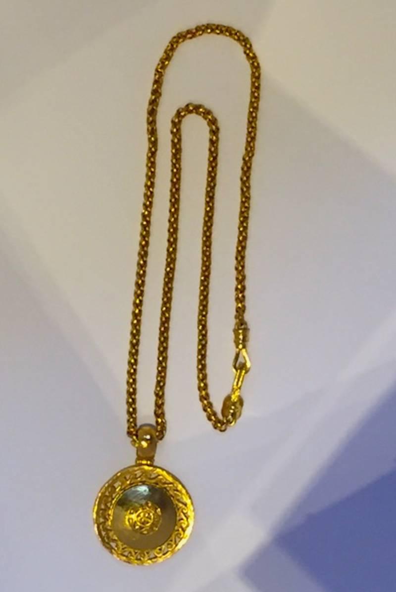 From the Chanel Autumn 1995 collection. Heavy barrel link chain with clasp measures 31.5 inches (80 cm) including the hook and eye clasp. Pendant measures 2 inches (5 cm) in diameter and 2.75 inches (7 cm) tall including the hinged bail. On front of