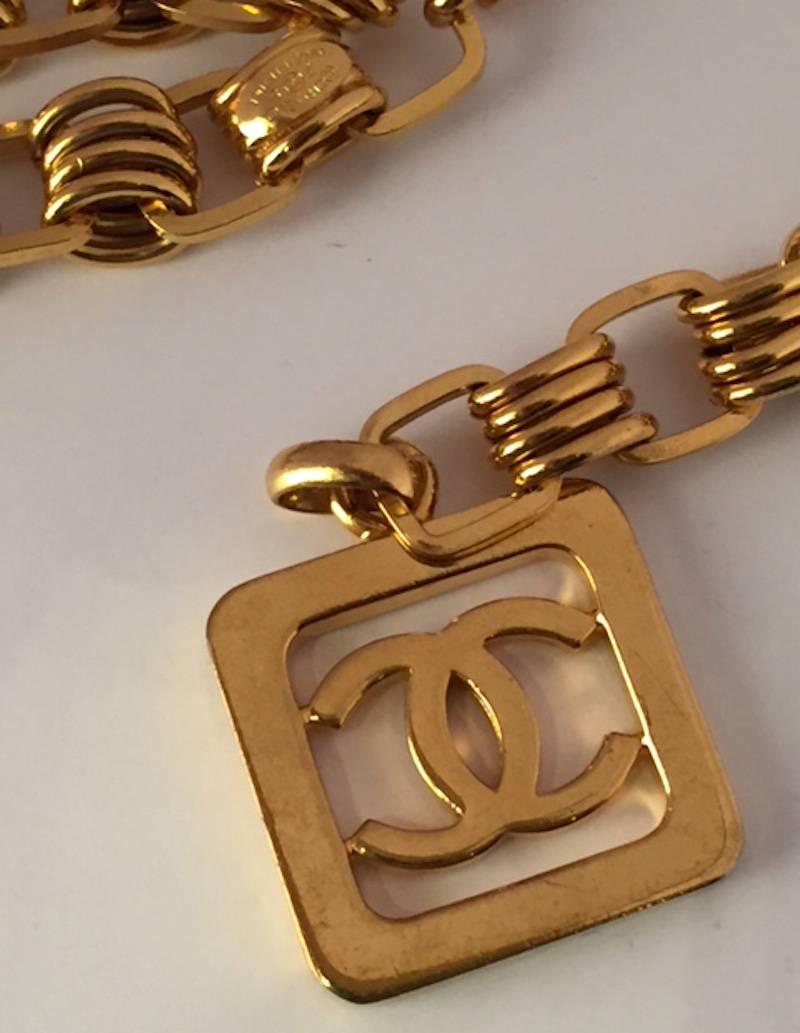 Produced in 1991. Chanel heavy multi link gold double swag belt with large square Chanel logo charm. The belt chain is made up of groups of 4 oval links alternating with a single rounded share link. Belt chain is 5/8 inch (1.5 cm) wide. Front of