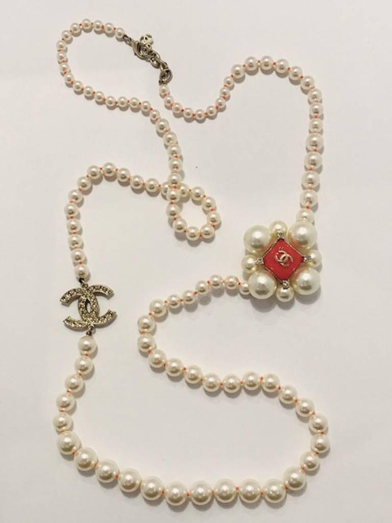 Created for the fall 2014 collection is this very long Chanel necklace of various size faux pearls. The pearls are graduated in size in between the medallion, the clasp and the double C logo. Pearls range in size from 1/4 to 5/8 of an inch in