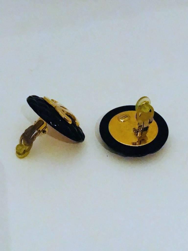 A classic pair of Chanel button earrings created by Victore de Castellane. Castellane was the head designer of Chanel and brought to the company by Karl Lagerfeld, the head designer of Chanel. The earrings each measure 1 3/8