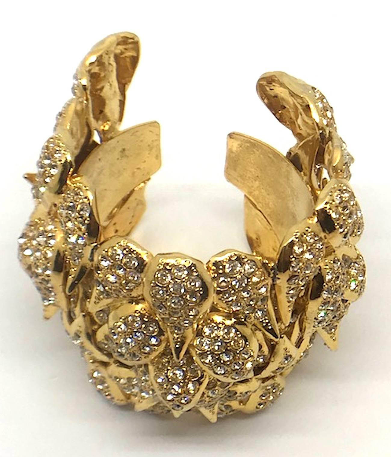 A true show stopper is this large 18K gilt and rhinestone accent layered leaves cuff circa the 1980s. The cuff if from the personal collection of fine and costume jewelry of Italian actress Elsa Martinelli. Several pieces in her collection are by