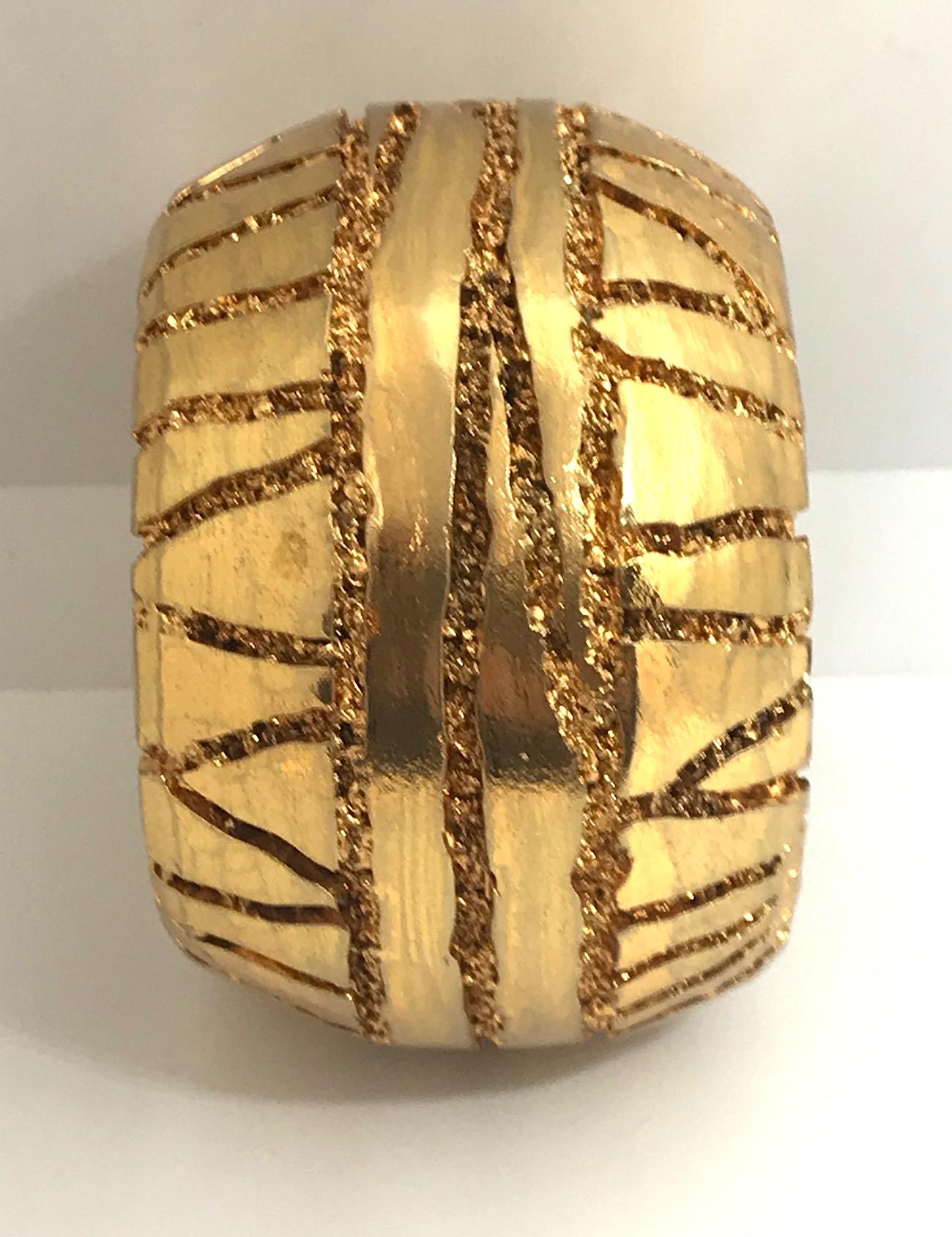 A true statement bracelet is this rare wide 1980s Christian Lacroix cuff. The molded and carved resin base has a heavy layer of 18K gold plated metal. It is cold to the touch and not a thin gold leaf. 2.5 inches wide. The interior diameter is 2.5