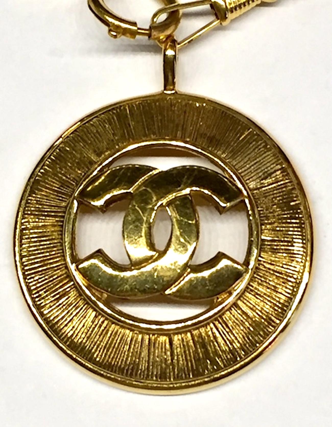 A wonderful early 1980s Chanel necklace with large round cut out CC logo pendant. The pendant hangs on a heavy large link watch chain style necklace. Each link is 1/4