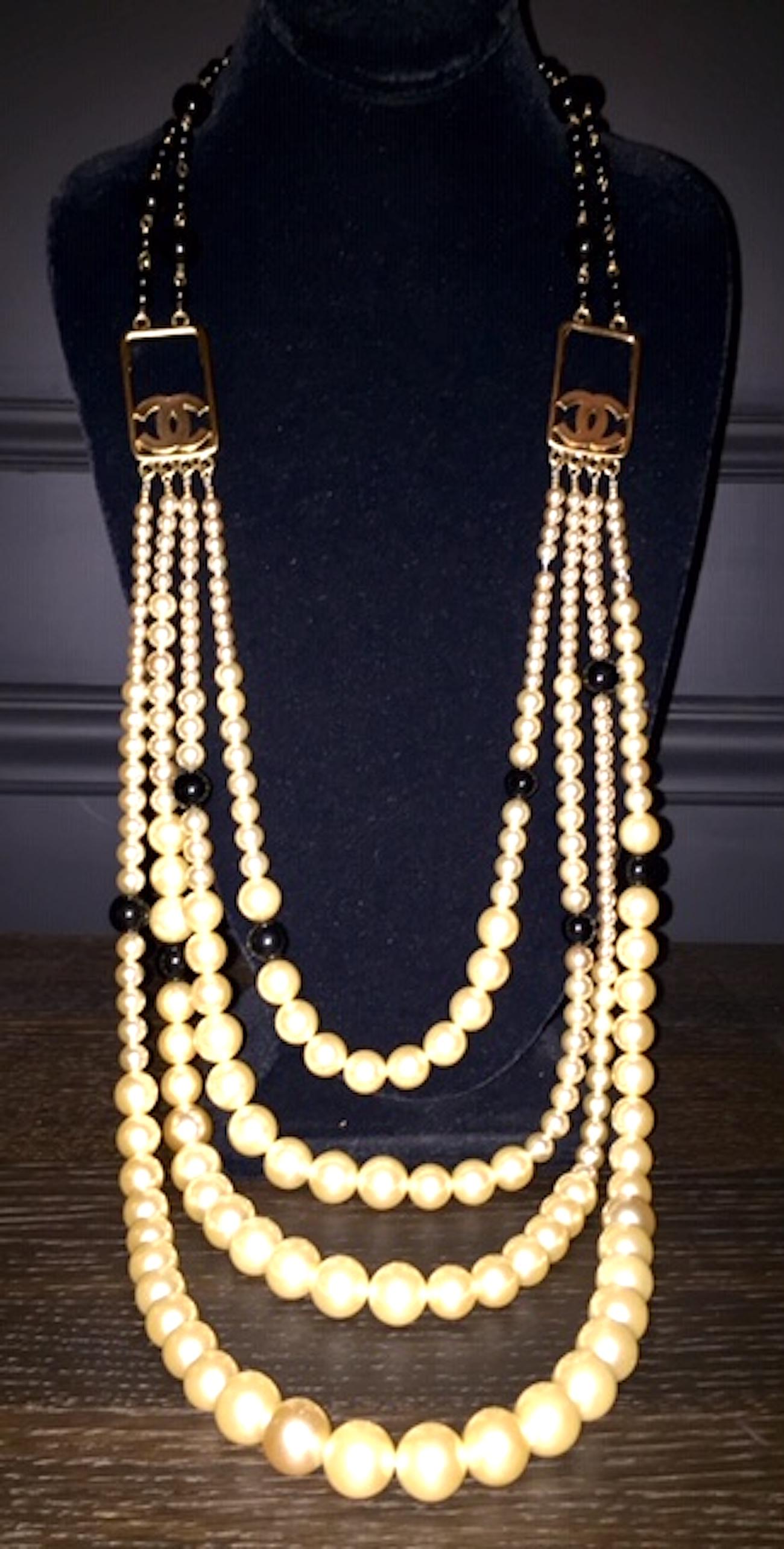 Amazing and dramatic Chanel faux pearl and black bead four strand necklace from the Spring 2003 collection. The back of the necklace consists of two strands of large and small black glass beads. They join to front four strands of graduated pearls by