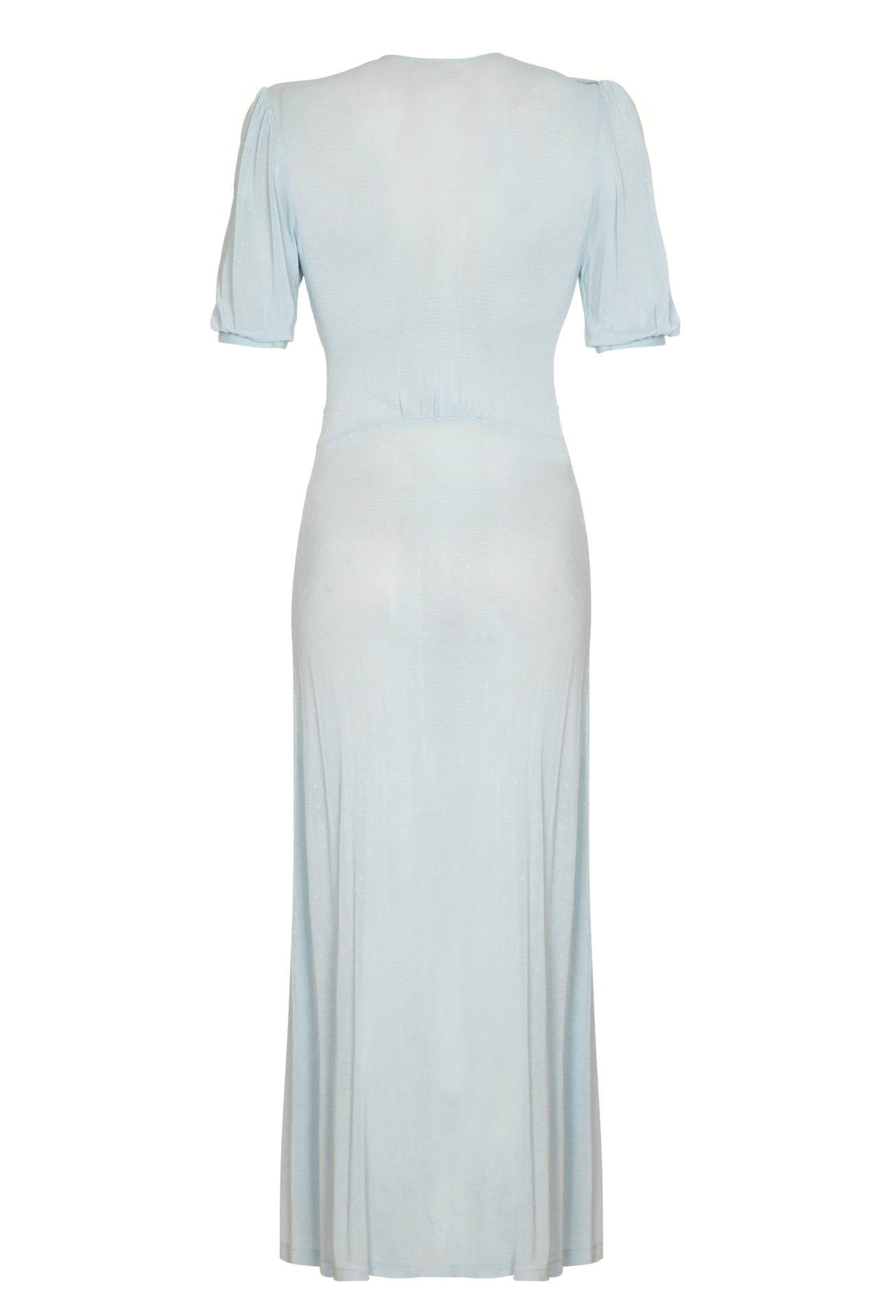 Beautifully soft pale blue fine knit dress with short puff sleeves, deep V neckline and pretty shaping around the bust.  A very wearable dress with no fastenings, it just slips on over the head and is in excellent condition.