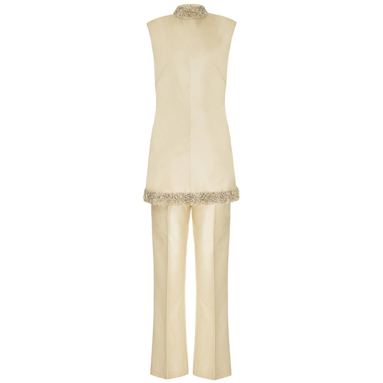 Outstanding 1960’s cream raw silk, three piece suit made up of jacket, tunic and waisted trousers from German designer and couturier Uli Richter. This outfit features heavily beaded sections around the neckline and hem of the tunic and on the