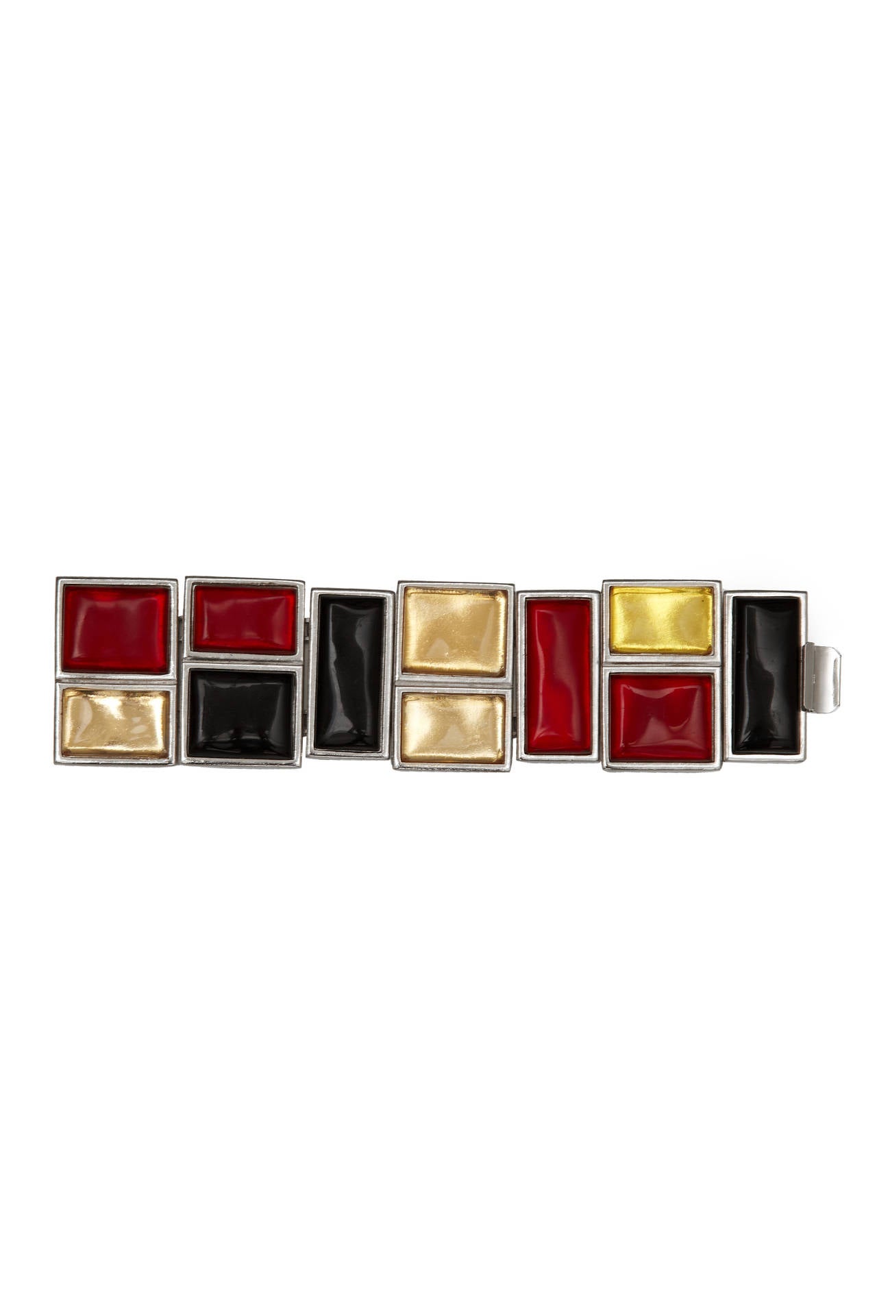 Fabulous vintage Yves Saint Laurent Mondrian style cuff bracelet made up of yellow, red and black glass sections backed on silver tone metal and hinged together. It fastens with a clasp between two sections and is a real statement piece in excellent