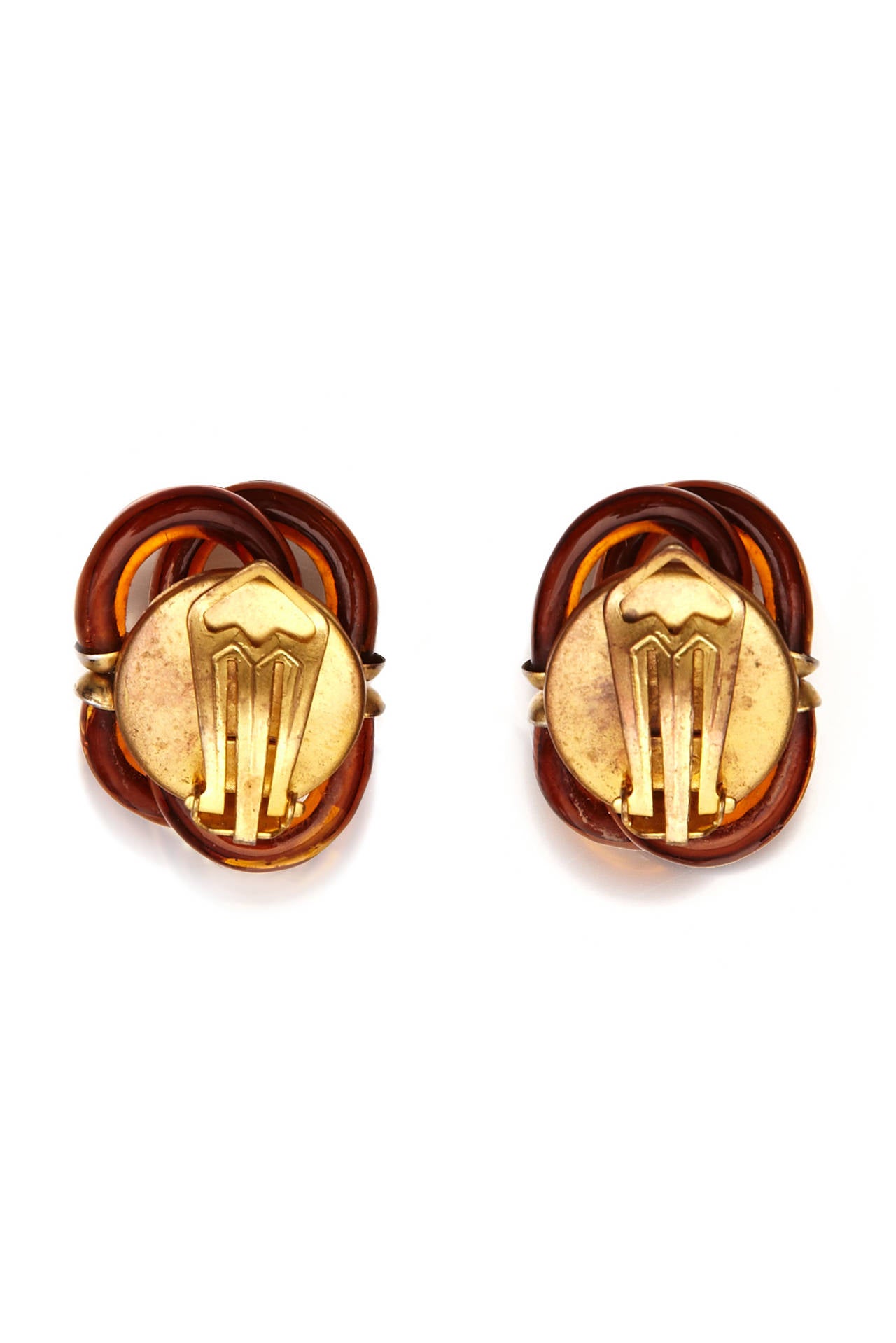 Fabulous and rare clip earrings by famous Venetian glass maker Archimede Seguso for Chanel. They are made up of interlocking brown blown glass curved tubes with gold tone metal and crystal details. They are unsigned but a very well documented design