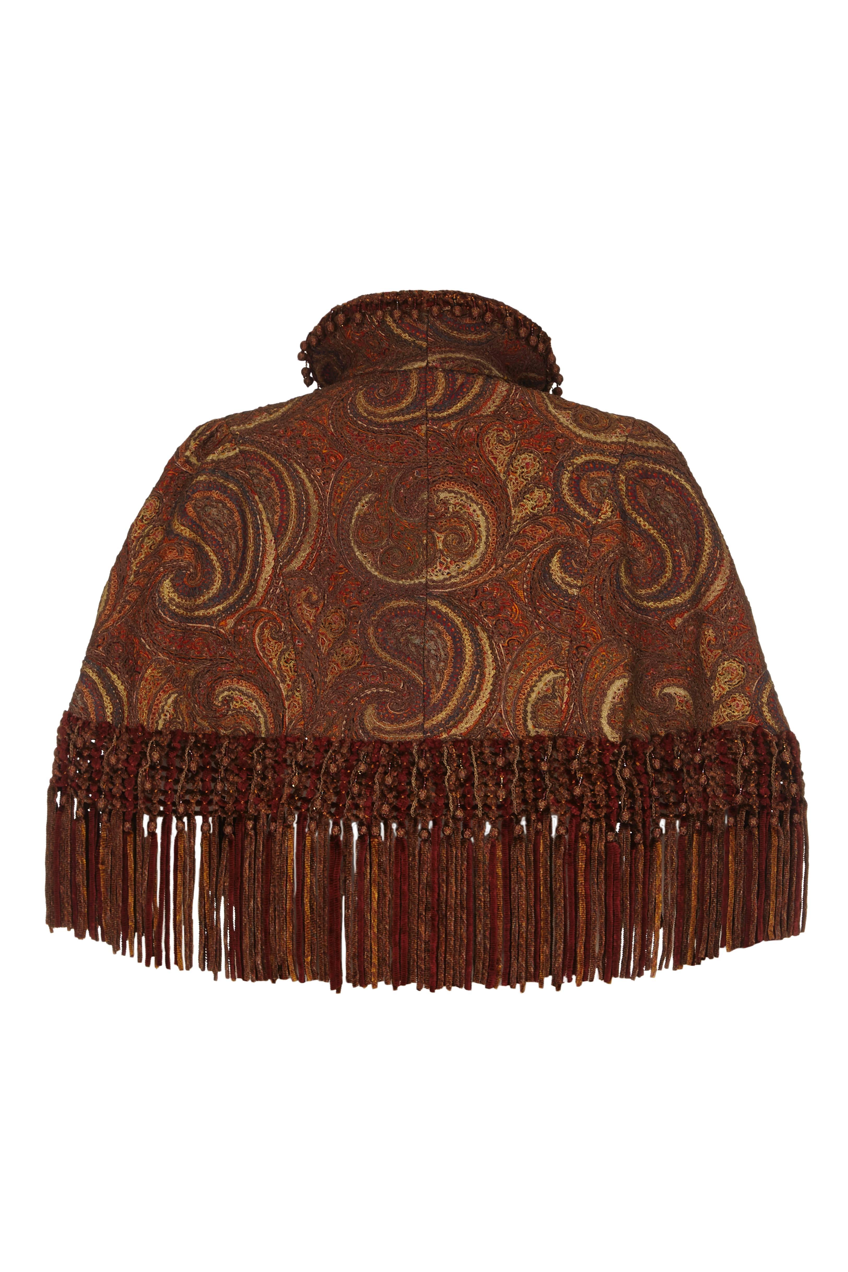 Exquisite Victorian cape in a lovely paisley fabric that has been heavily embroidered in bronze and gold tones to give a rich textured, heavy and luxurious finish.  The cape dates from the 1870s and is trimmed at the hem with coordinating chenille