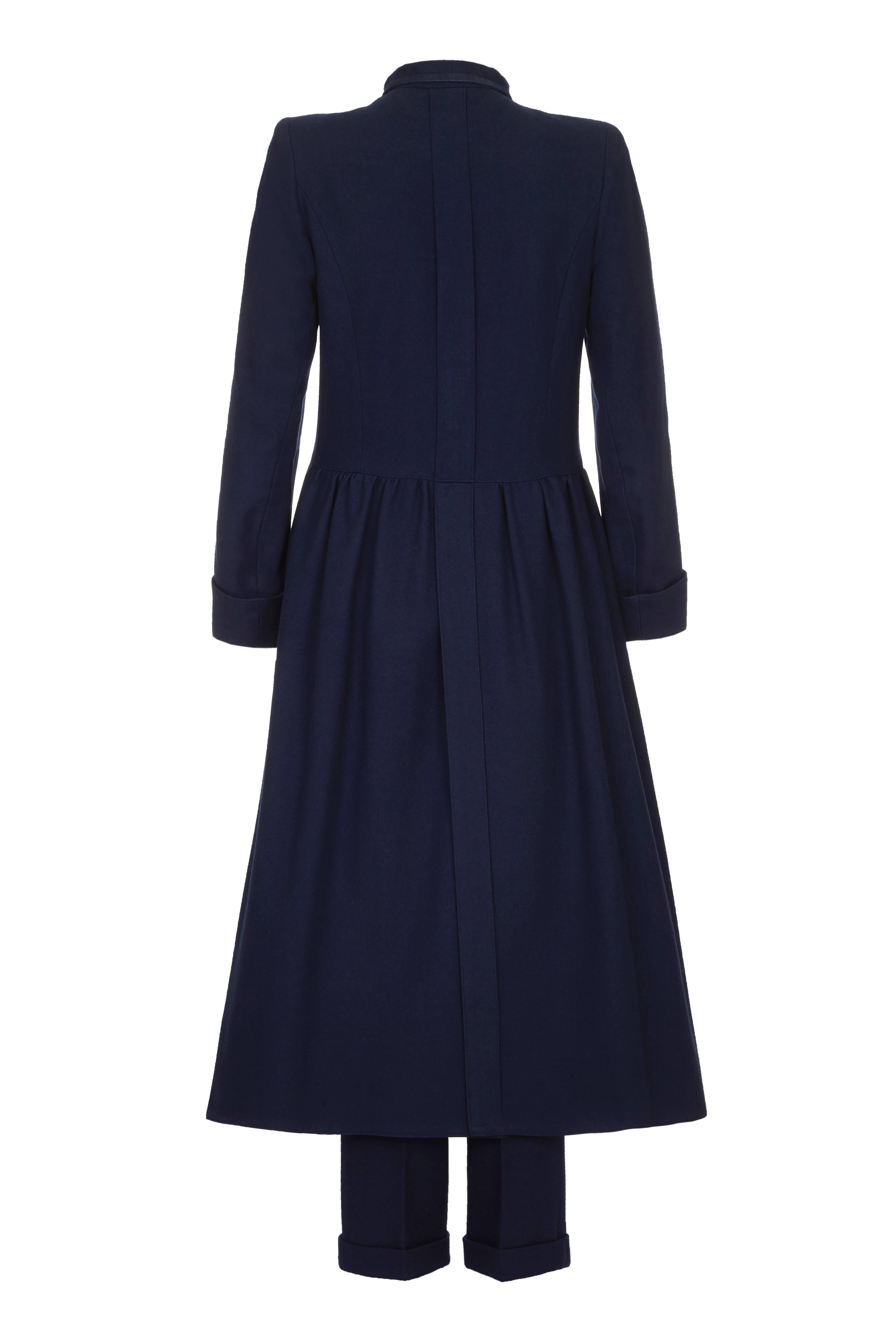 Fantastic vintage Chloe navy wool dress coat dating from 1979.  This military style piece fastens at the front with silver buttons and has two patch breast pockets.  There is an open vent to the back of the skirt, which overlaps from the waist to
