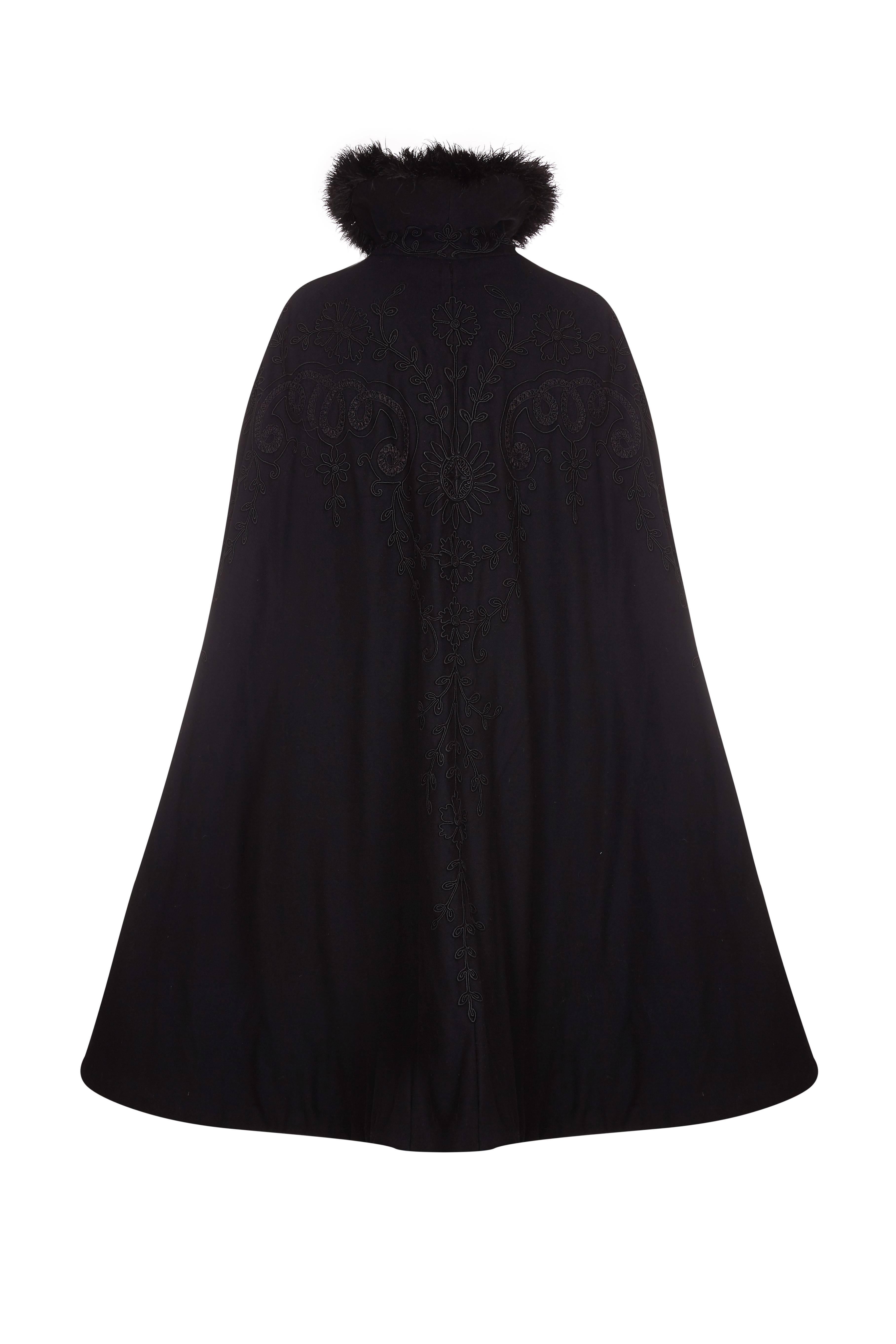 Lovely Victorian black wool cape with floral soutache work. It is shaped to fit around the shoulders, finishes at the knee and has buttons and loops to fasten at the front with hooks and eyes continuing to the hem.  Inside it is fully lined and