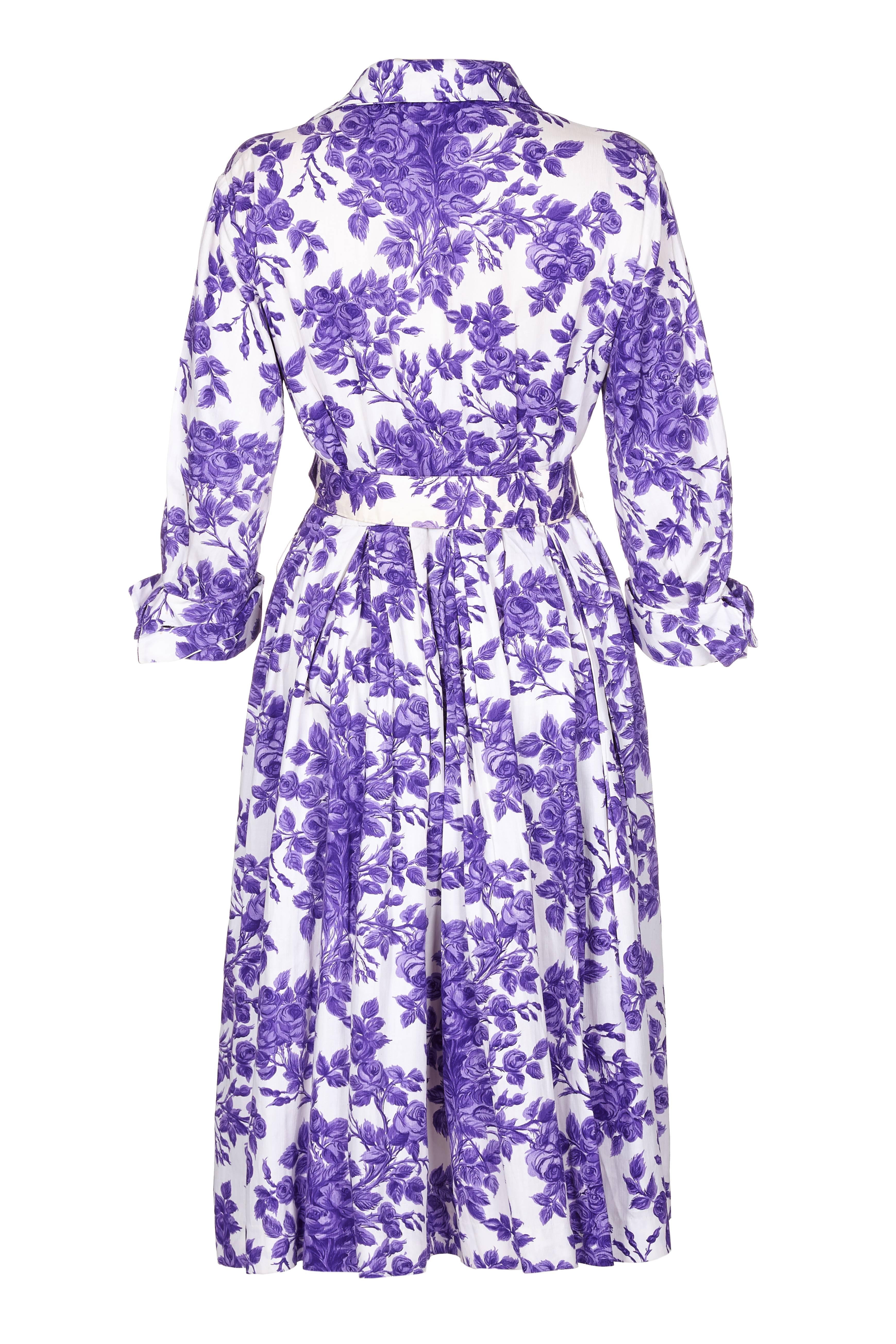 This lovely 1960s Tudor shirt waister dress with a purple rose print is made from a mid weight cotton. It will be perfect in the summer and the bright pattern will make a very nice dress for a wedding. The sleeves come to just above the elbow and