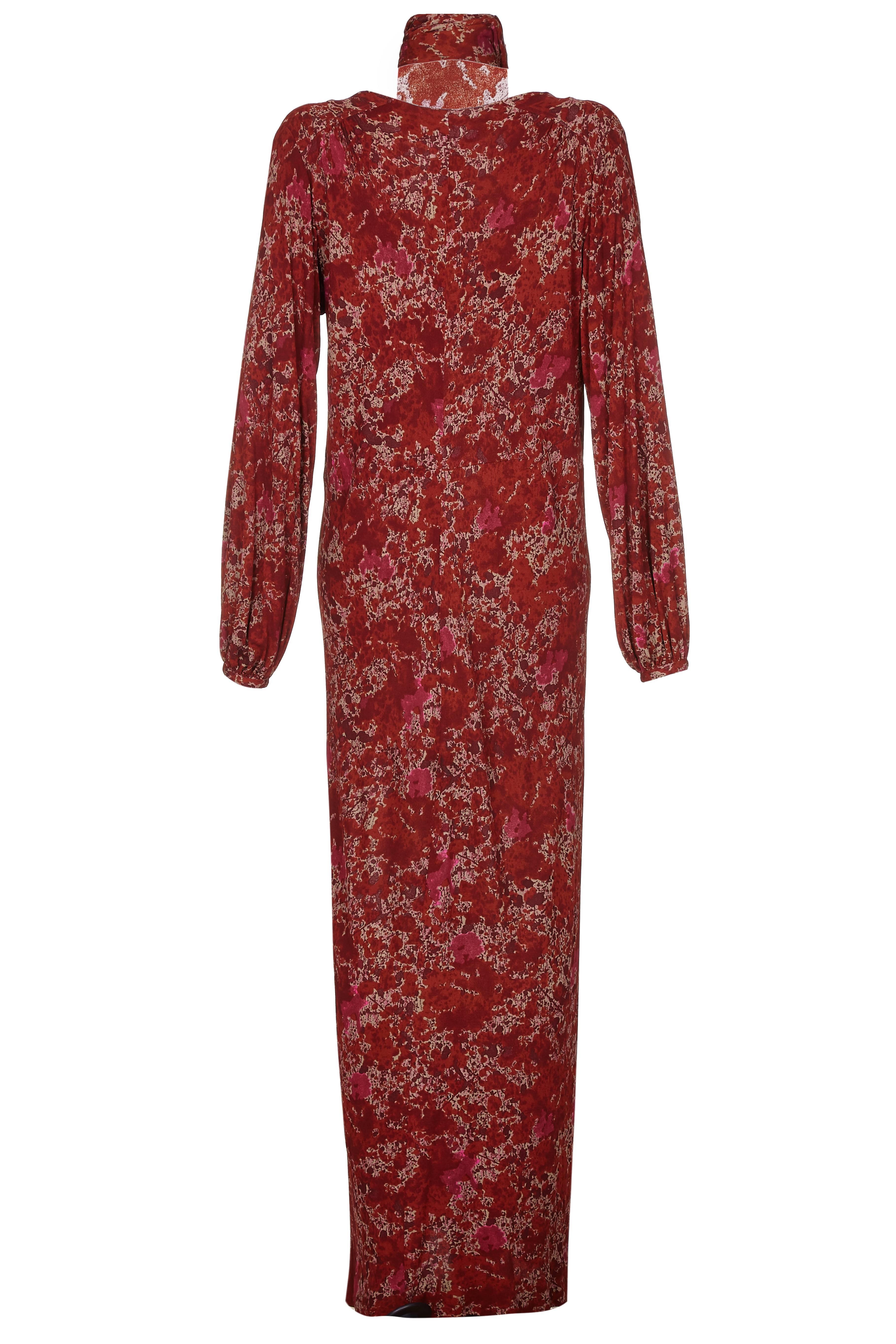 This gorgeous 1970s silk jersey maxi dress by Givenchy has long blouson sleeves which fasten at the wrist. The medium weight silk fabric hangs beautifully from a deep v neck which has hook and eye fastenings, giving the freedom to adjust the depth