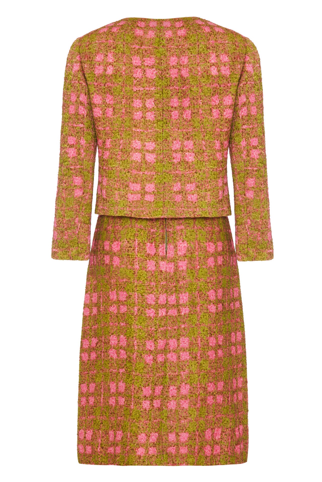 Beautiful pink and green woven ribbon checked skirt suit circa 1960s by Christian Dior with the New York label attached.  The jacket fastens with two buttons at the front, poppers at the neck and is fully lined in a pale pink silk.  The skirt is