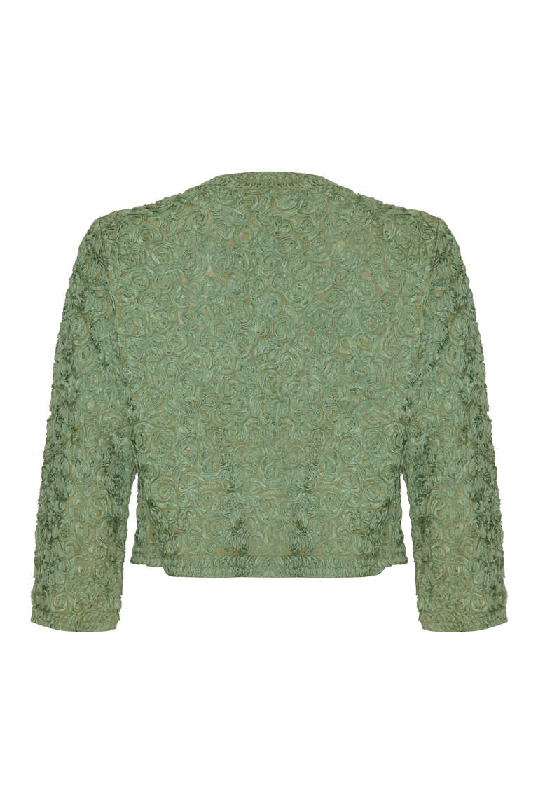 A lovely vintage cropped jacket with a romantic feel.  This piece is made up of swirls of pretty green ribbon stitched on top of a knitted background to create a gorgeous textured surface.  The jacket is straight cut with ¾ sleeves and easy to throw