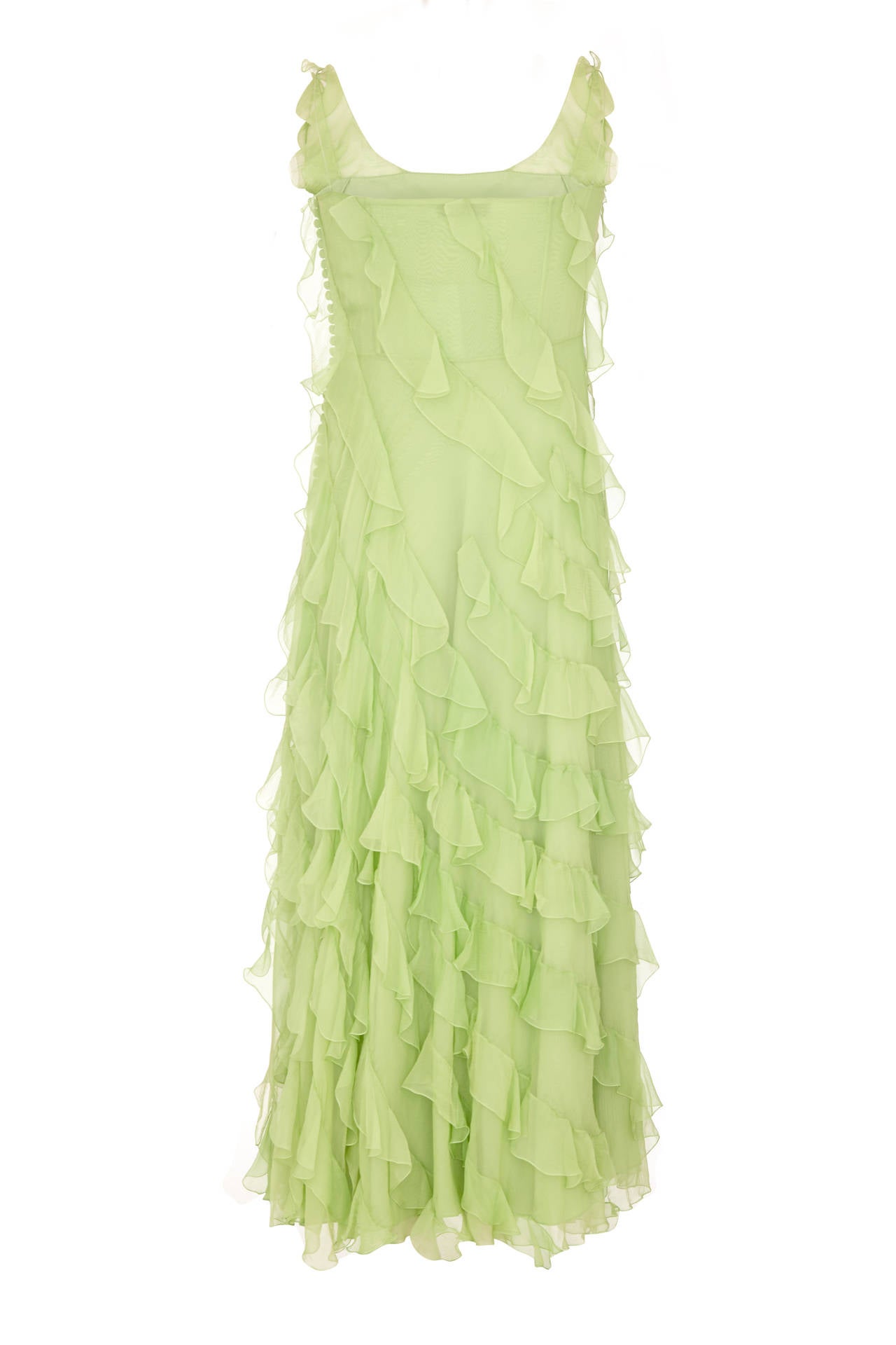 Stunning late 90s pale lime green chiffon bias cut gown by John Galliano for Christian Dior.  This beautiful dress features thin spaghetti straps and diagonal chiffon ruffles throughout. It is labelled UK size 12/ US size 8 but is more like a UK 10/