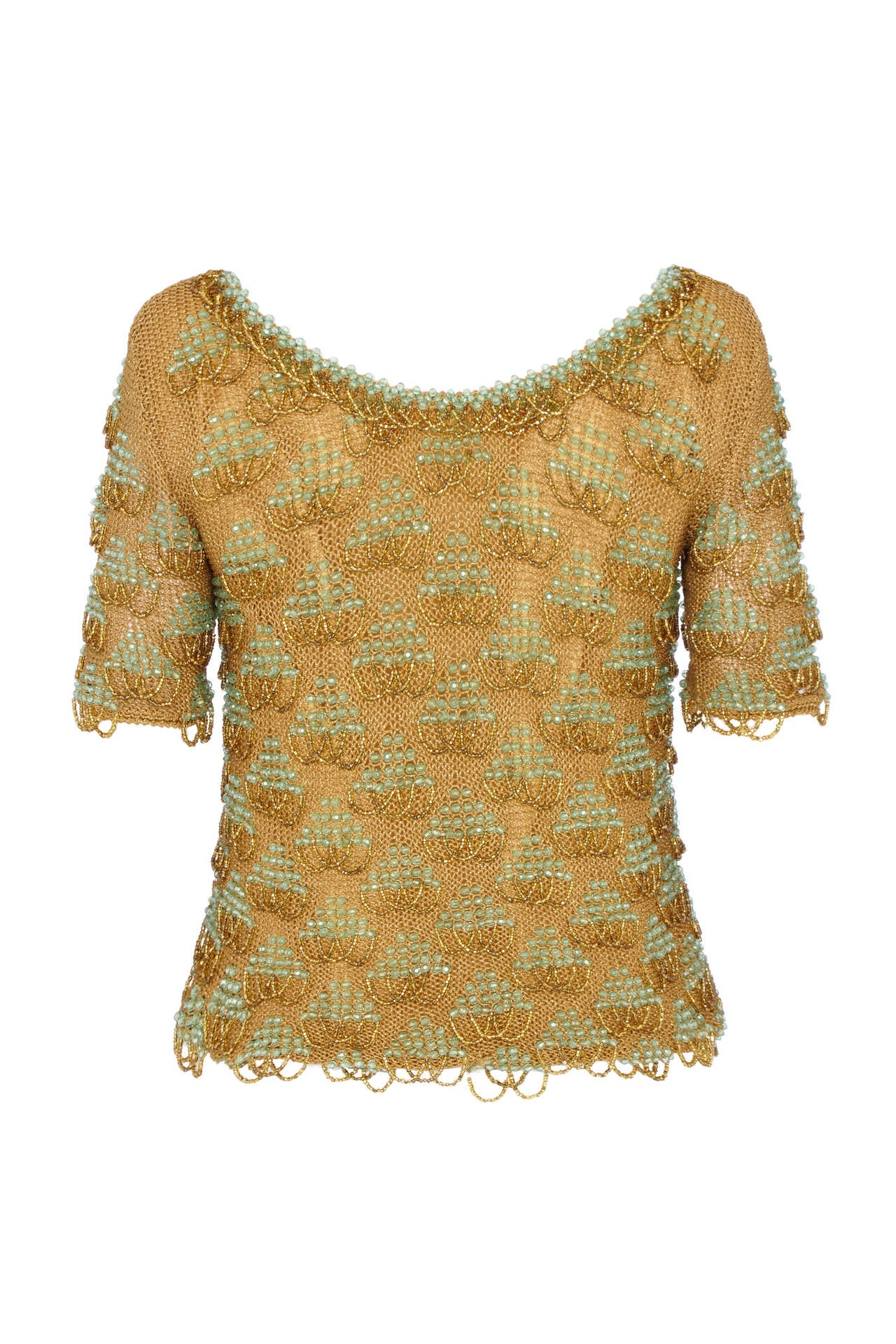 Amazing gold knitted top with heavy turquoise and gold beading throughout.  This top has no fastenings and goes on over the head like a t-shirt, it is fully lined through the bodice but not the sleeves leaving them slightly sheer. The weight of this