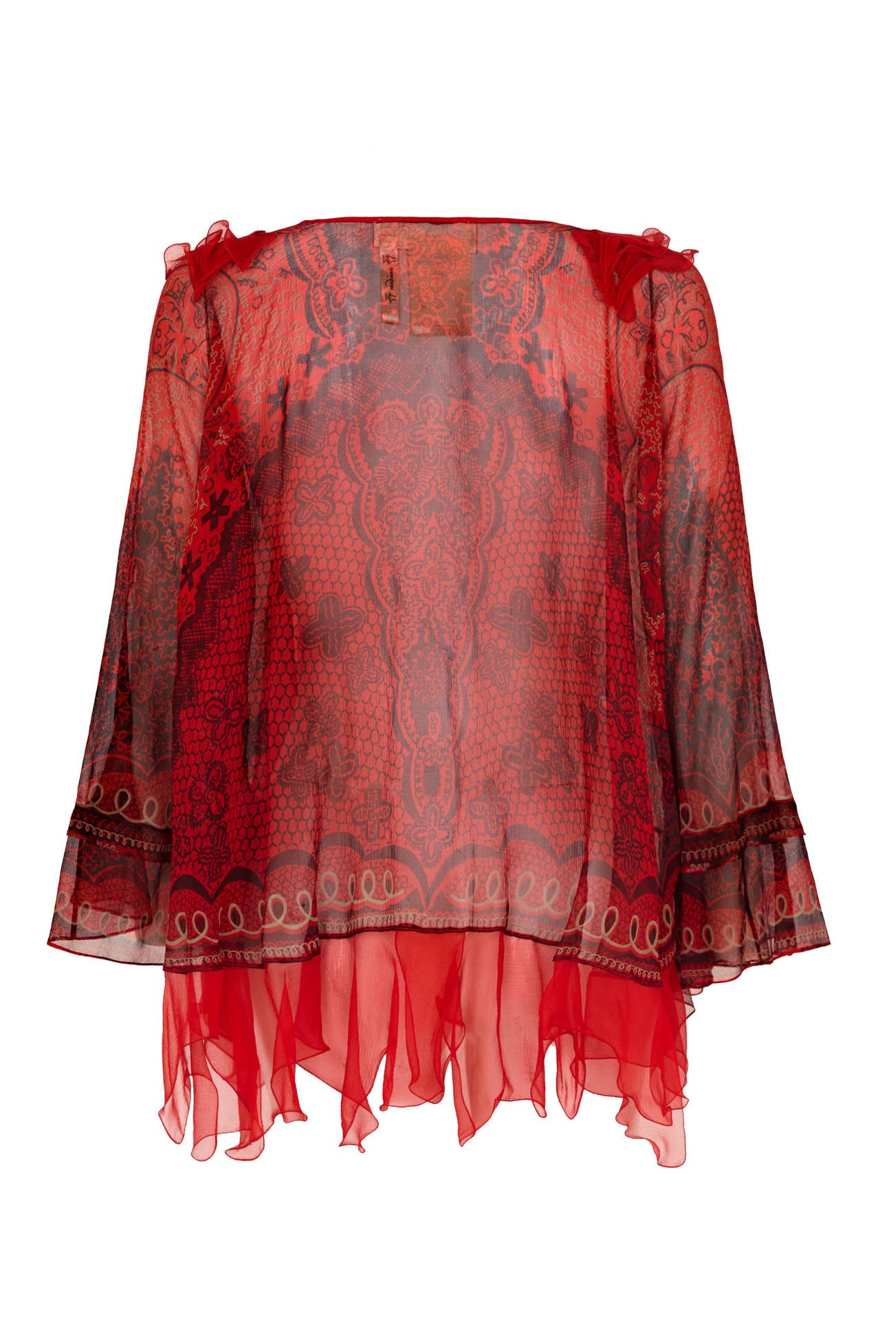 Rare and flamboyant printed kaftan style blouse from iconic British designer Zandra Rhodes.  This 100% silk piece features red chiffon ruffles down the front and around the hem with a V neckline. Labelled a size medium it would fit a variety of