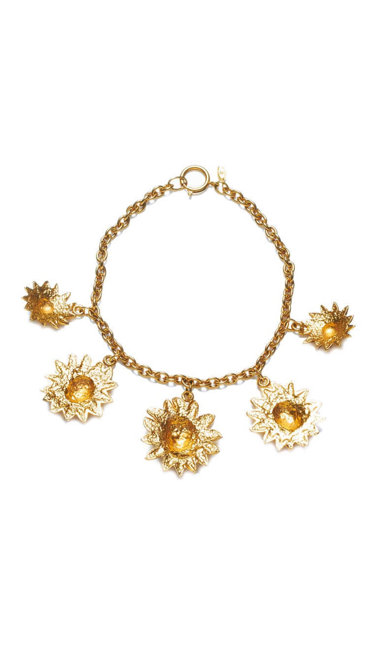 Amazing Chanel necklace from the early 80’s made up of a gold tone metal chain with five lion head charms of varying size in embossed gilt metal.  Around the face of each lion’s face is a ring of double C logos and it is marked on the back of the