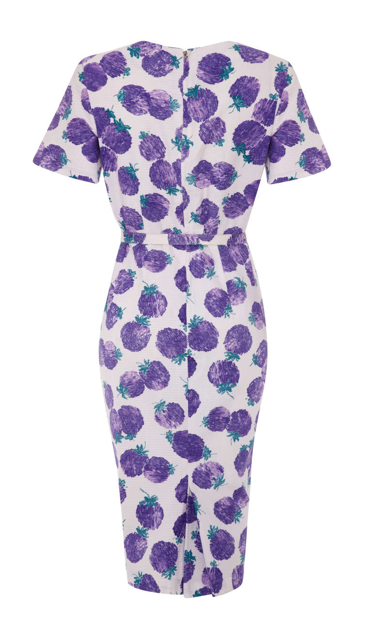 Fun little 50’s dress with an abstract purple fruit print on a white textured cotton.  This below the knee length dress features short sleeves, a square neckline and pleats over the bust. It comes with the original matching belt, fastens with a zip