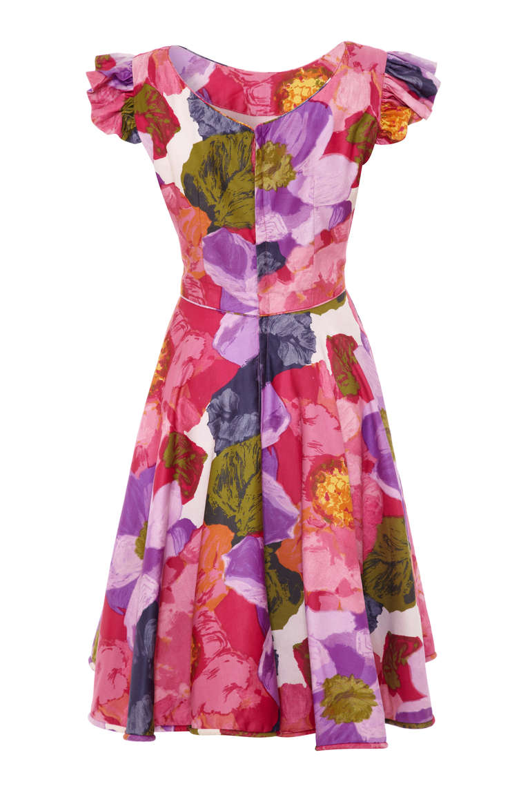 One of the sweetest 50’s day dresses going. This floral piece is made of a heavy weight cotton and fully lined throughout with a matching piped hem, waist and neckline. The dress also features a full skirt, little ruffle cap sleeves and a lower