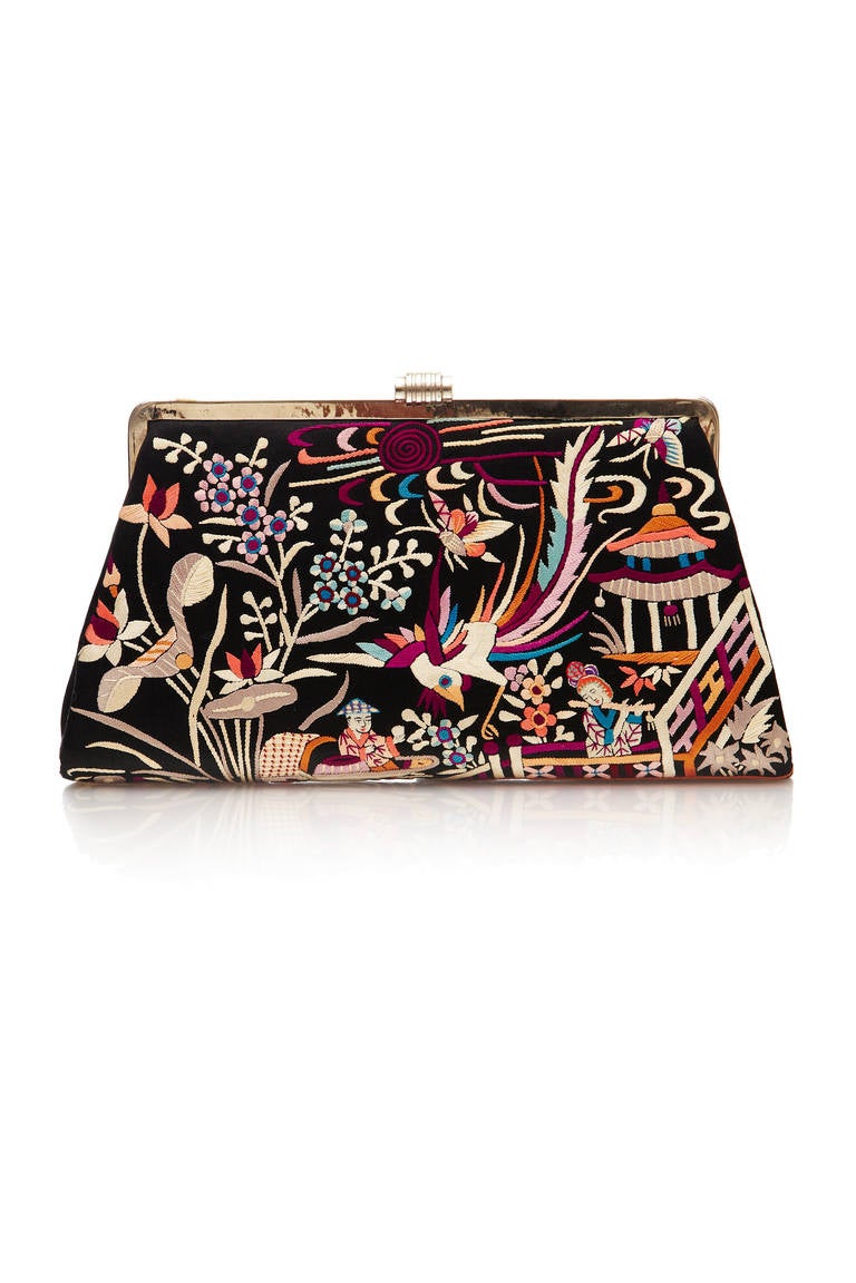 This is an absolutely stunning silk clutch bag of Chinese origin dating from the 1920s. It consists of black silk background with very detailed, elaborate and vibrant embroidery depicting Chinese scenes, birds and floral motifs. Internally the bag