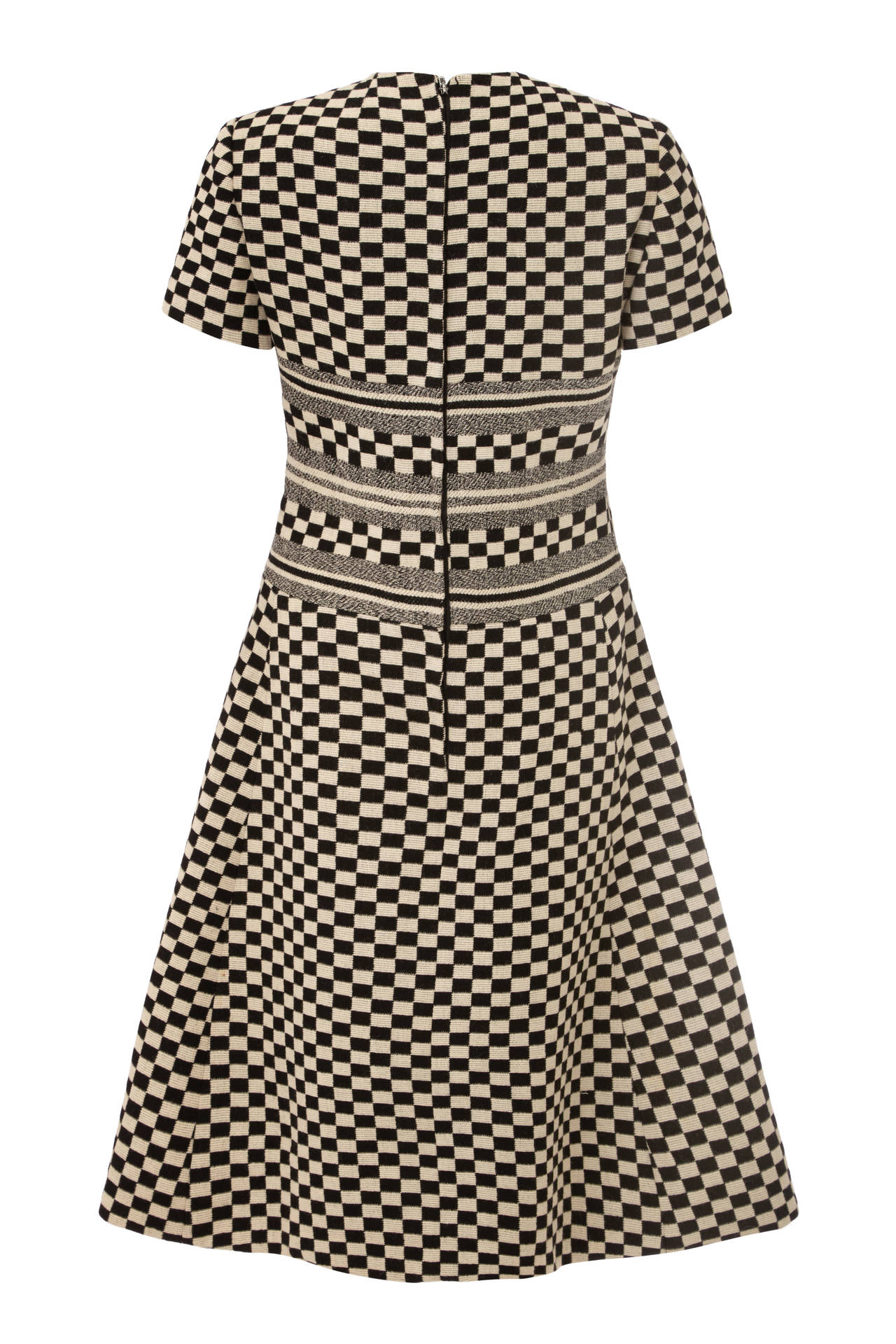 Fantastic black and white checked dress from Doirling by Christian Dior. Typical of the style of the day this piece features three monochrome stripes to the bodice and pockets at the hips. It is fully lined, fastens at the back with a zip and is in