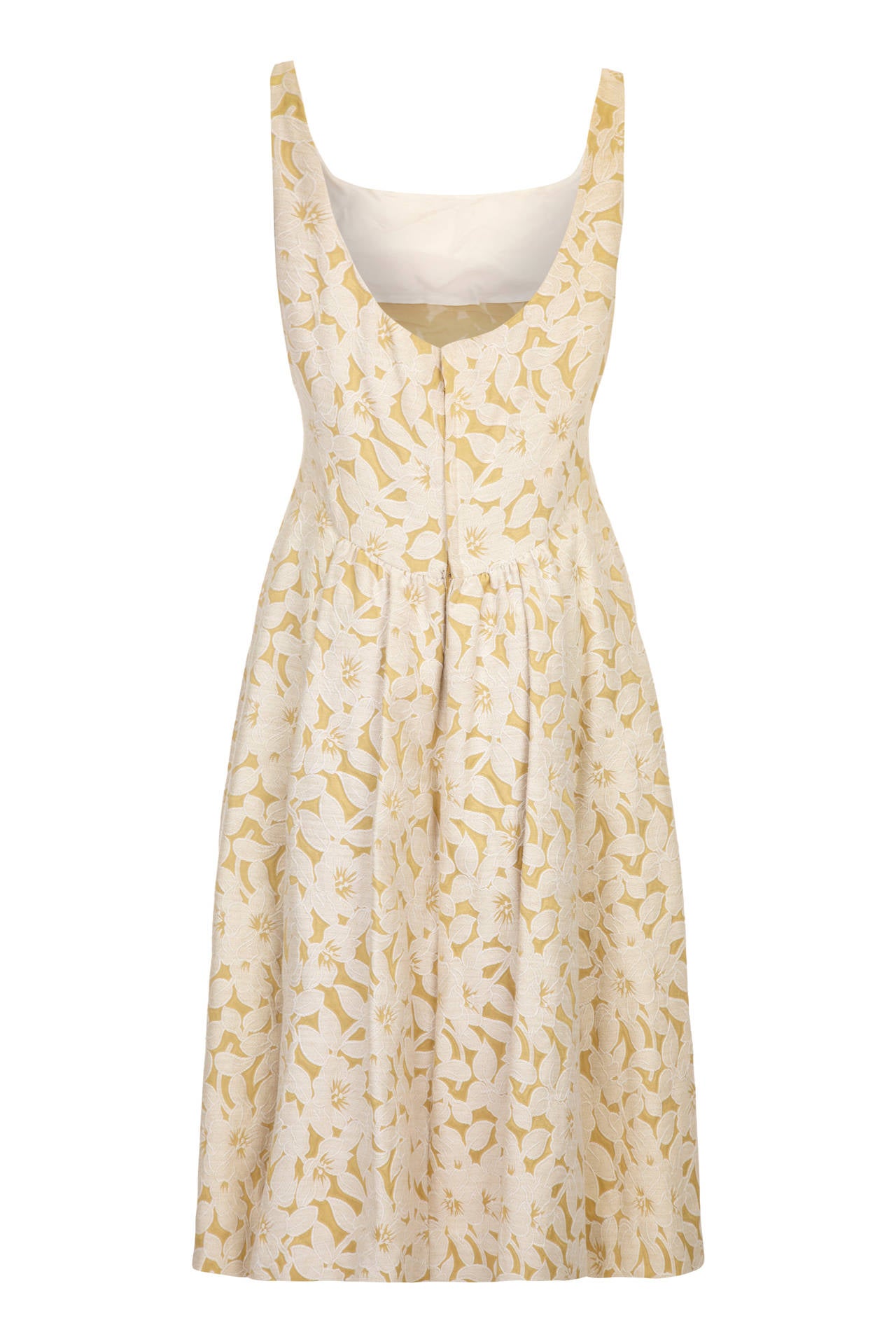 Gorgeous 1950s sleeveless, calf length dress in the softest gold and cream floral brocade by design label Rappi.  It features a low scoop at the back with gathers at the waist.  It is lined in organza, fastens at the back with a zip and is in