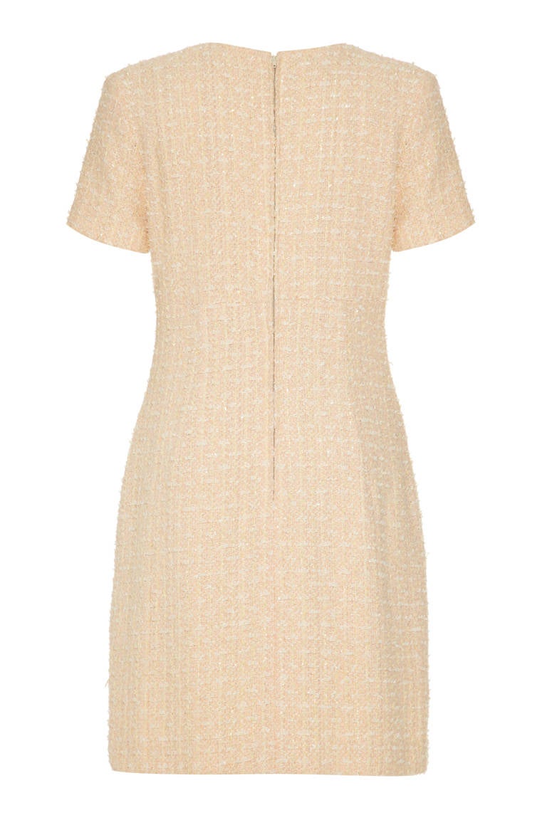 A beautiful French couture made short-sleeved shift dress in pale peach ‘fantasy’ tweed with a silver thread running throughout.  A possible Chanel sample this dress is extremely wearable for day or night and is fully lined in a soft ivory silk