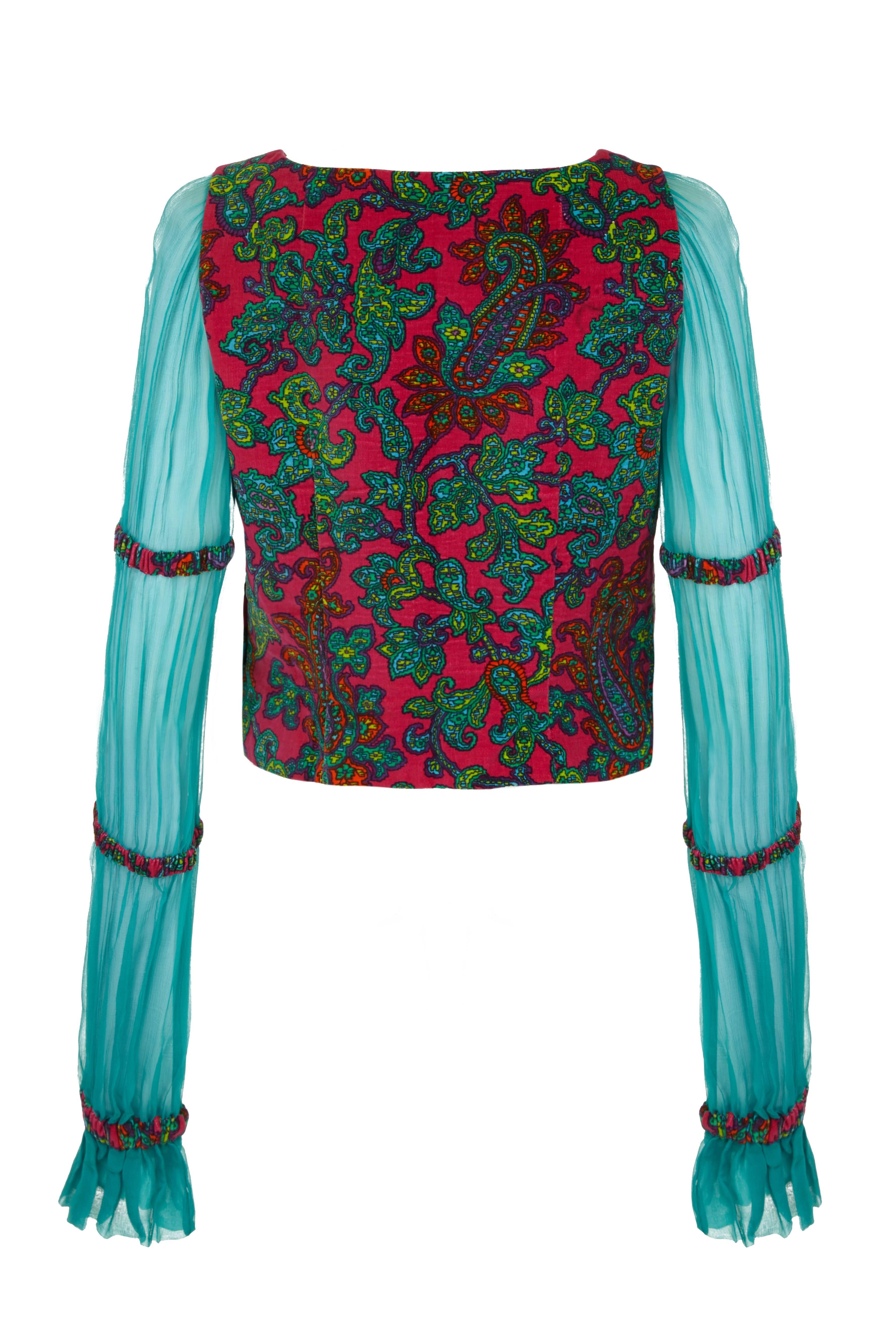Fabulous vintage 1970s couture made velvet blouse with long chiffon sleeves.   This vibrant and unusual piece features a bright pink and green paisley print on the velvet bodice with coordinating turquoise chiffon sleeves in sections with